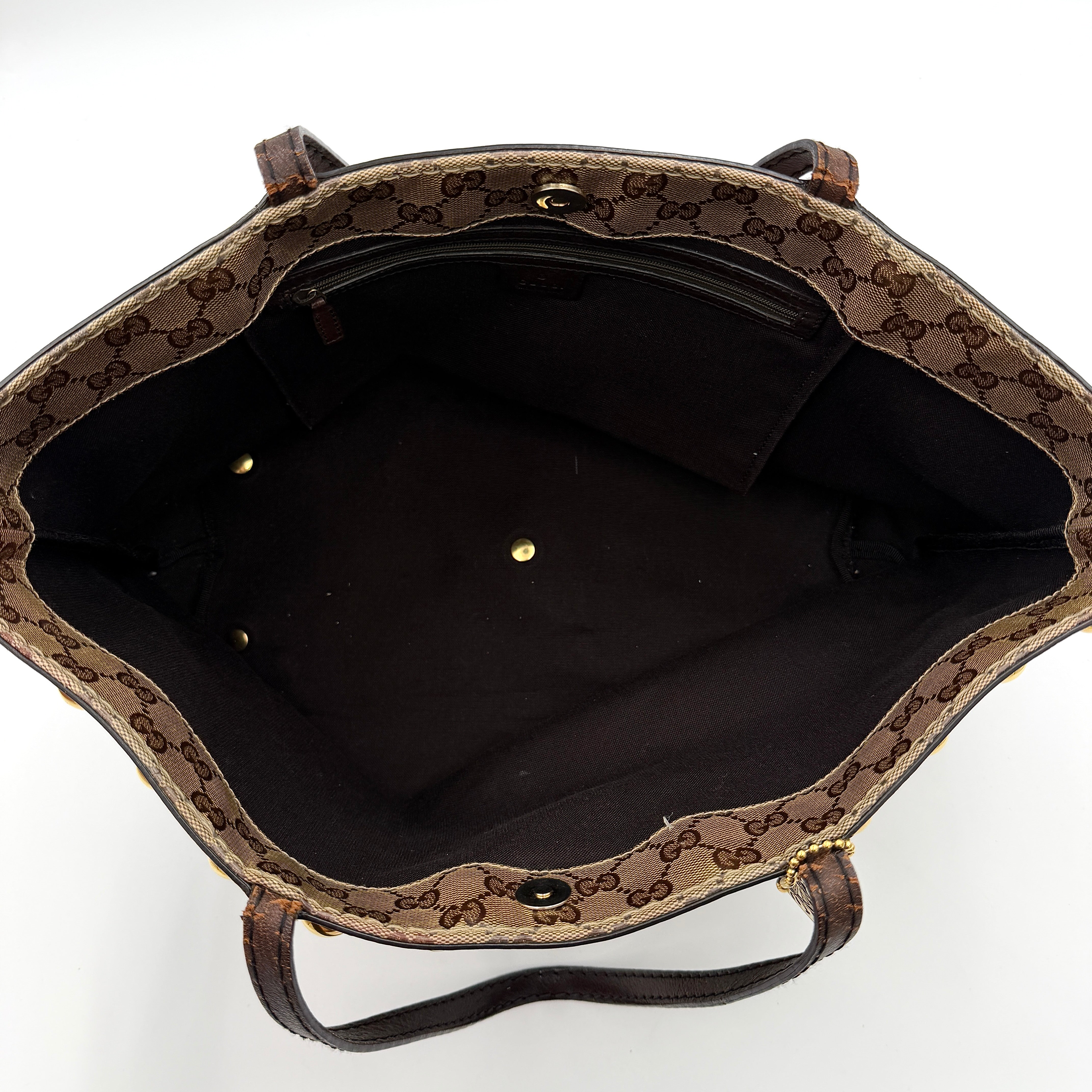 Gucci Babouska shoulder bag in GG monogram crystal canvas with gold-tone stud details and brown leather trim.