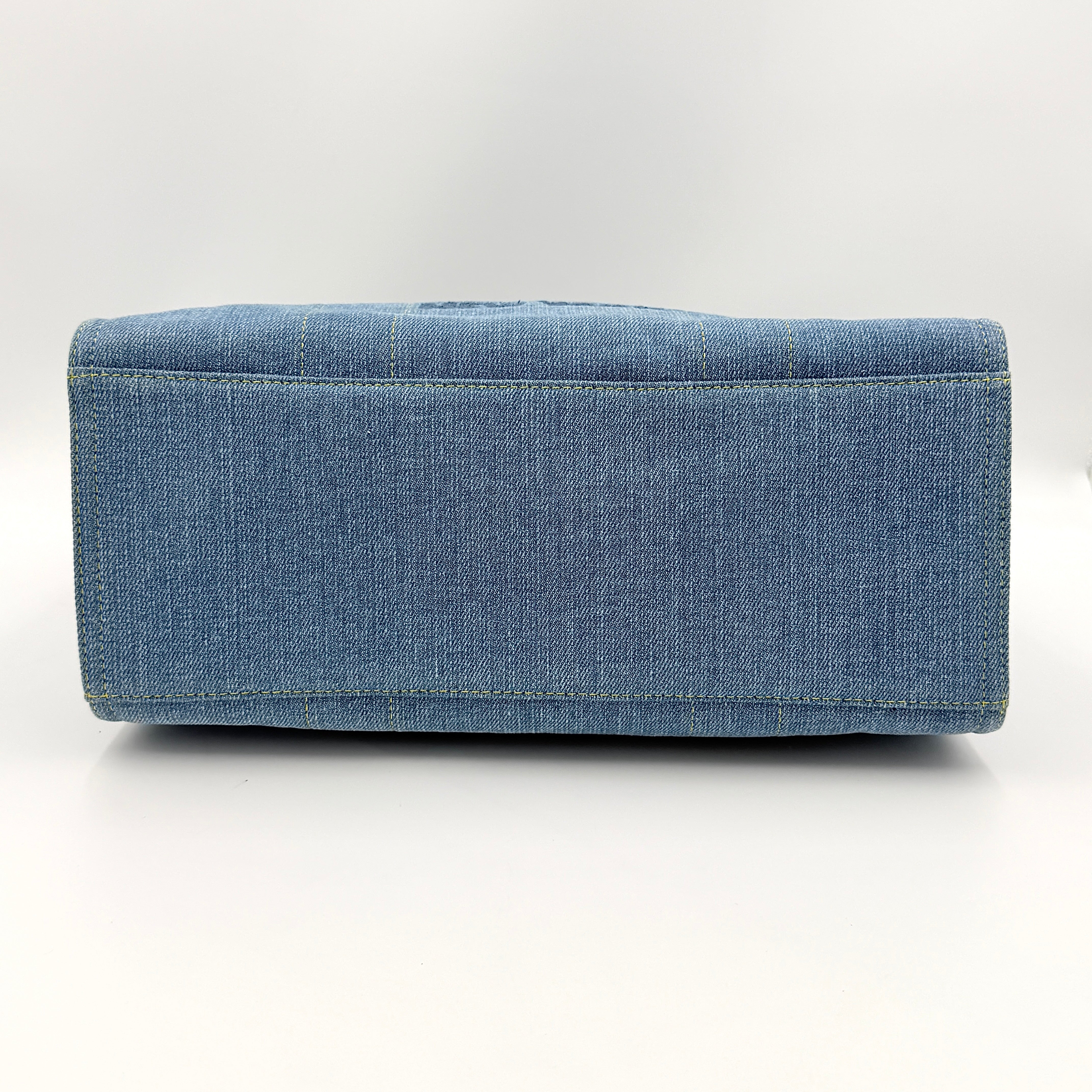 Coach denim 2Way Logo 20 Tote Bag in blue, embroidered with 'Coach New York', shown with detachable navy strap.