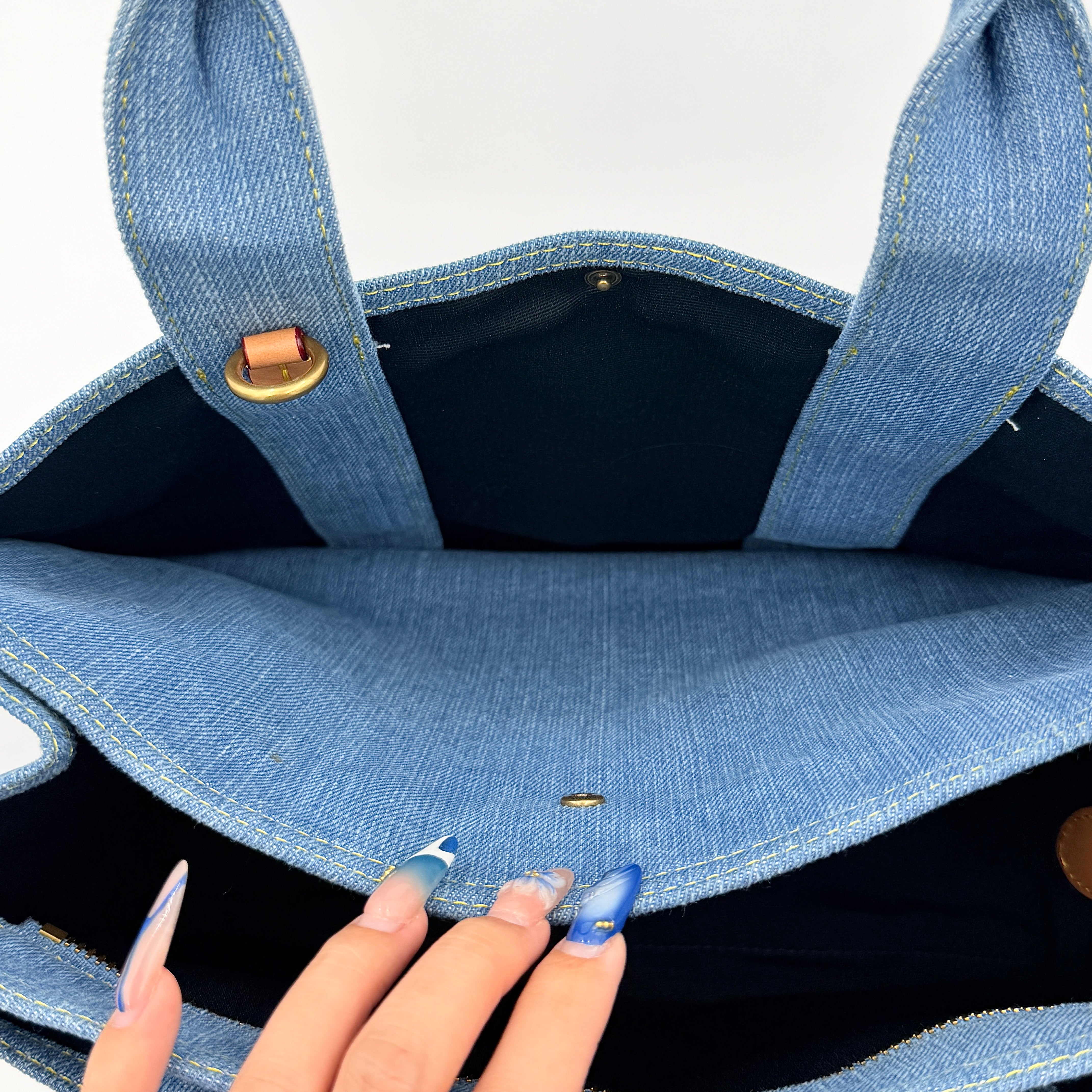 Coach denim 2Way Logo 20 Tote Bag in blue, embroidered with 'Coach New York', shown with detachable navy strap.
