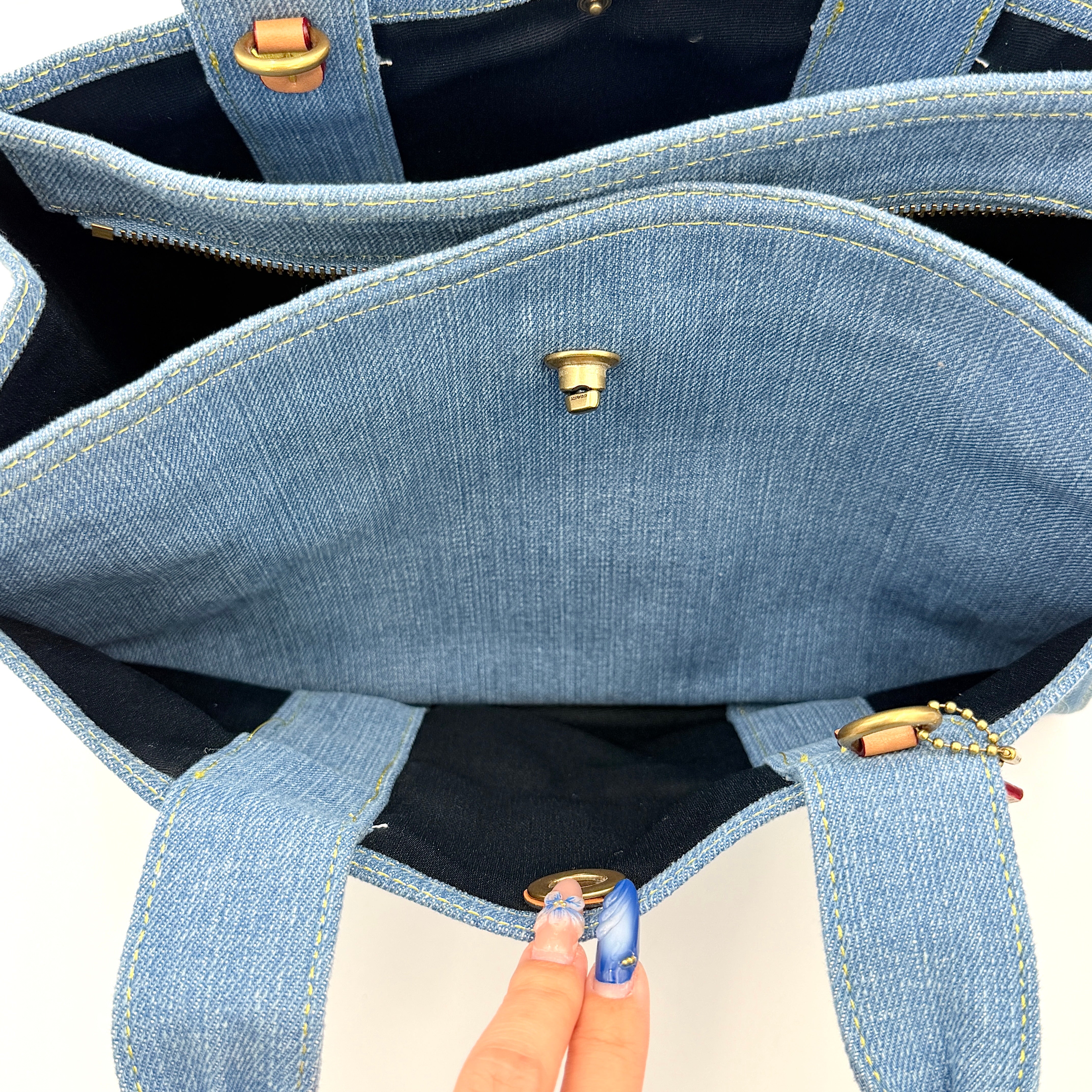 Coach denim 2Way Logo 20 Tote Bag in blue, embroidered with 'Coach New York', shown with detachable navy strap.