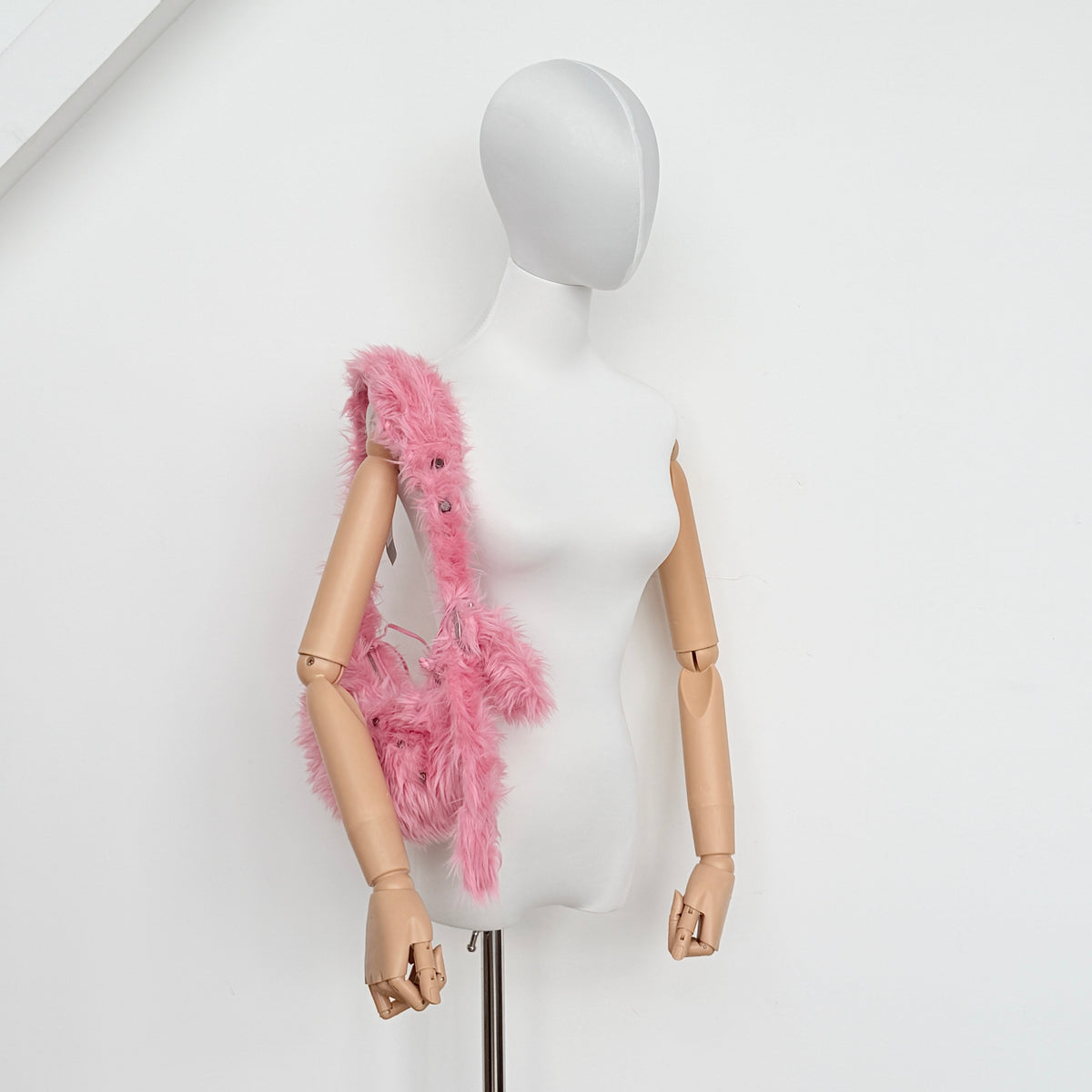 Balenciaga XS Le Cagole Shoulder Bag in sweet pink faux fur with heart-shaped mirror charm and silver hardware, styled on its original dust bag.