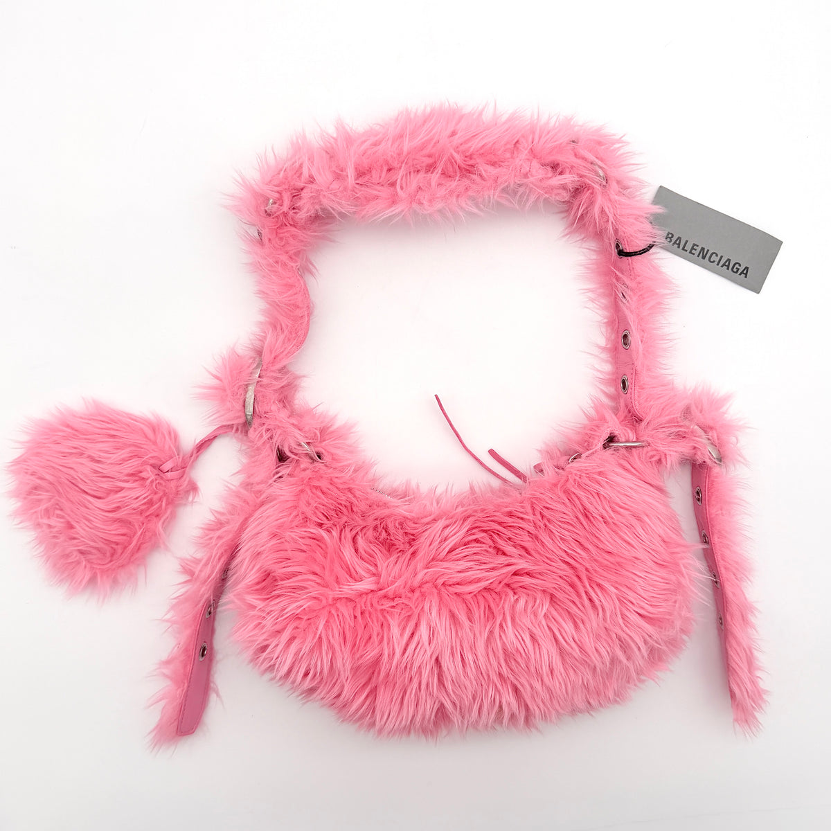 Balenciaga XS Le Cagole Shoulder Bag in sweet pink faux fur with heart-shaped mirror charm and silver hardware, styled on its original dust bag.
