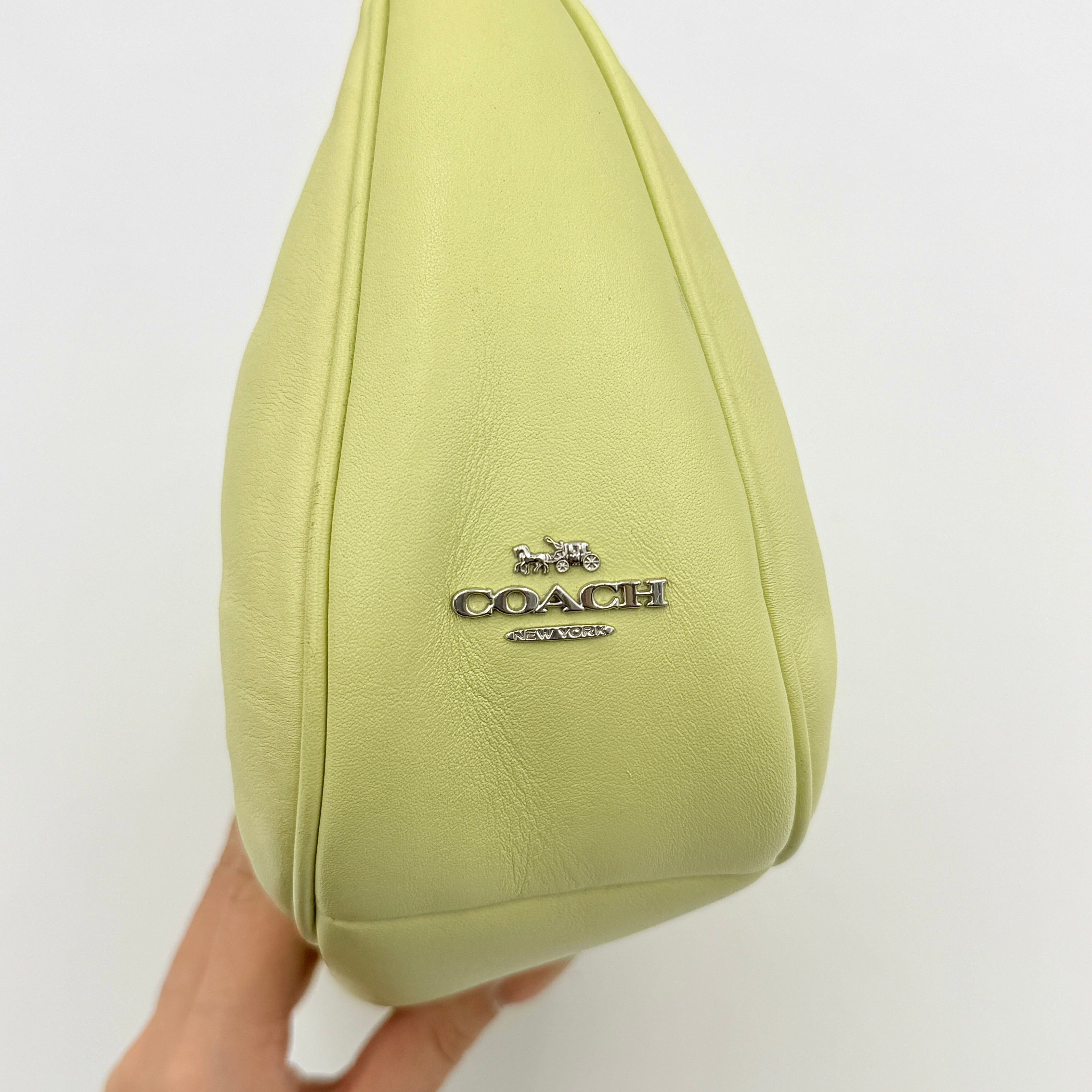 Coach 2Way C Teri Quilted Shoulder Bag in pastel green leather with oversized chain handle and detachable strap, displayed against a clean background.