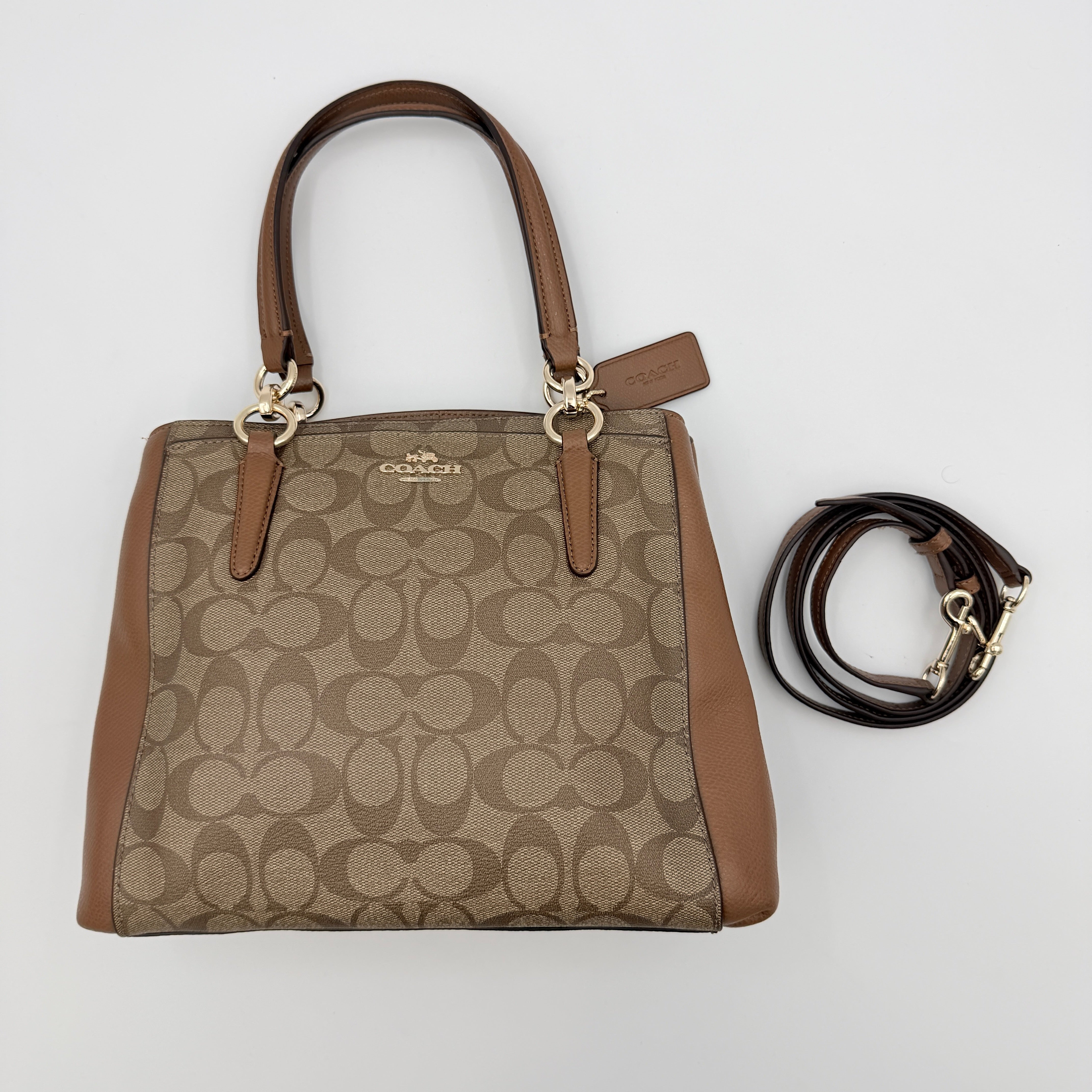 Coach Mini Christie Carryall in brown canvas and leather, shown with top handles and detachable strap.