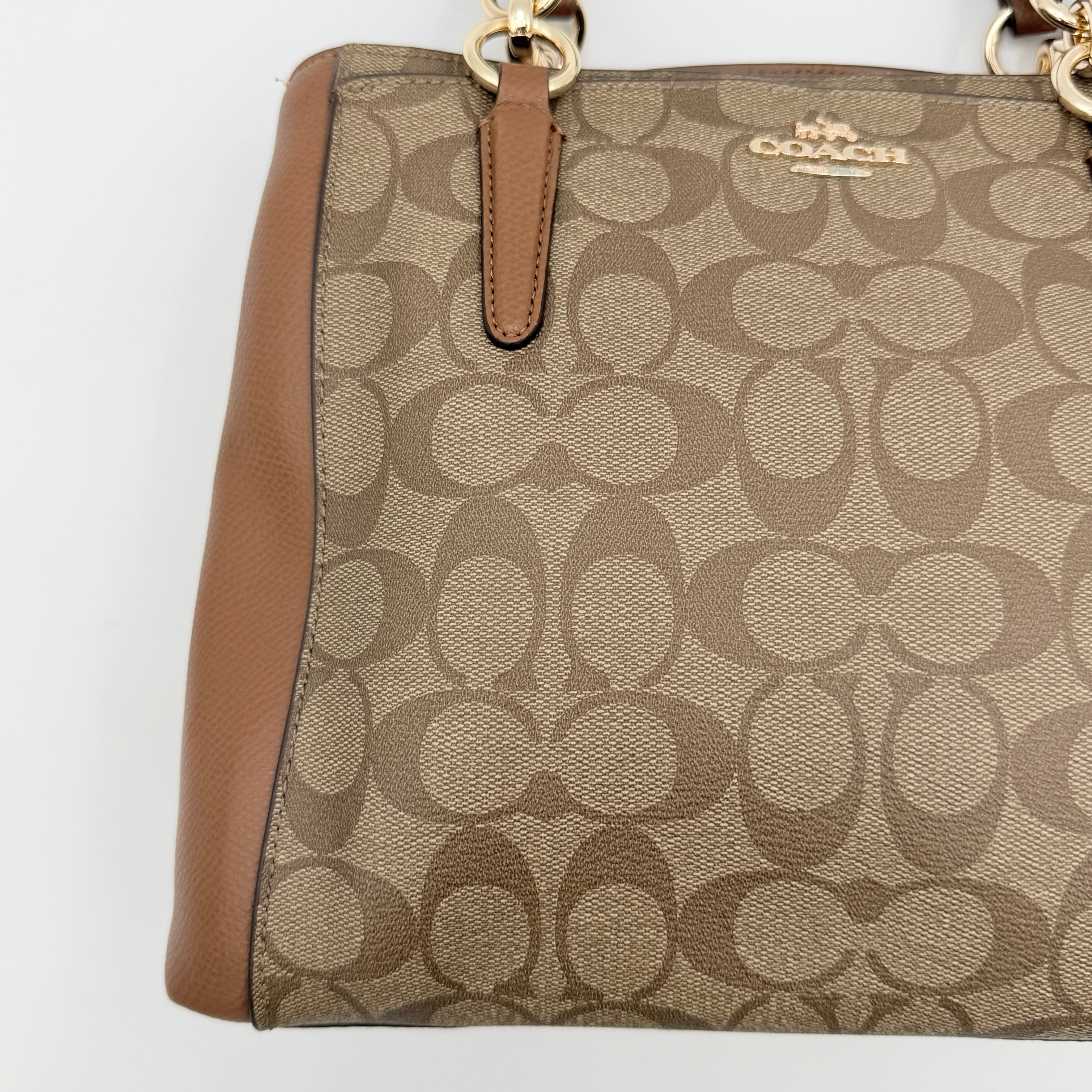 Coach Mini Christie Carryall in brown canvas and leather, shown with top handles and detachable strap.