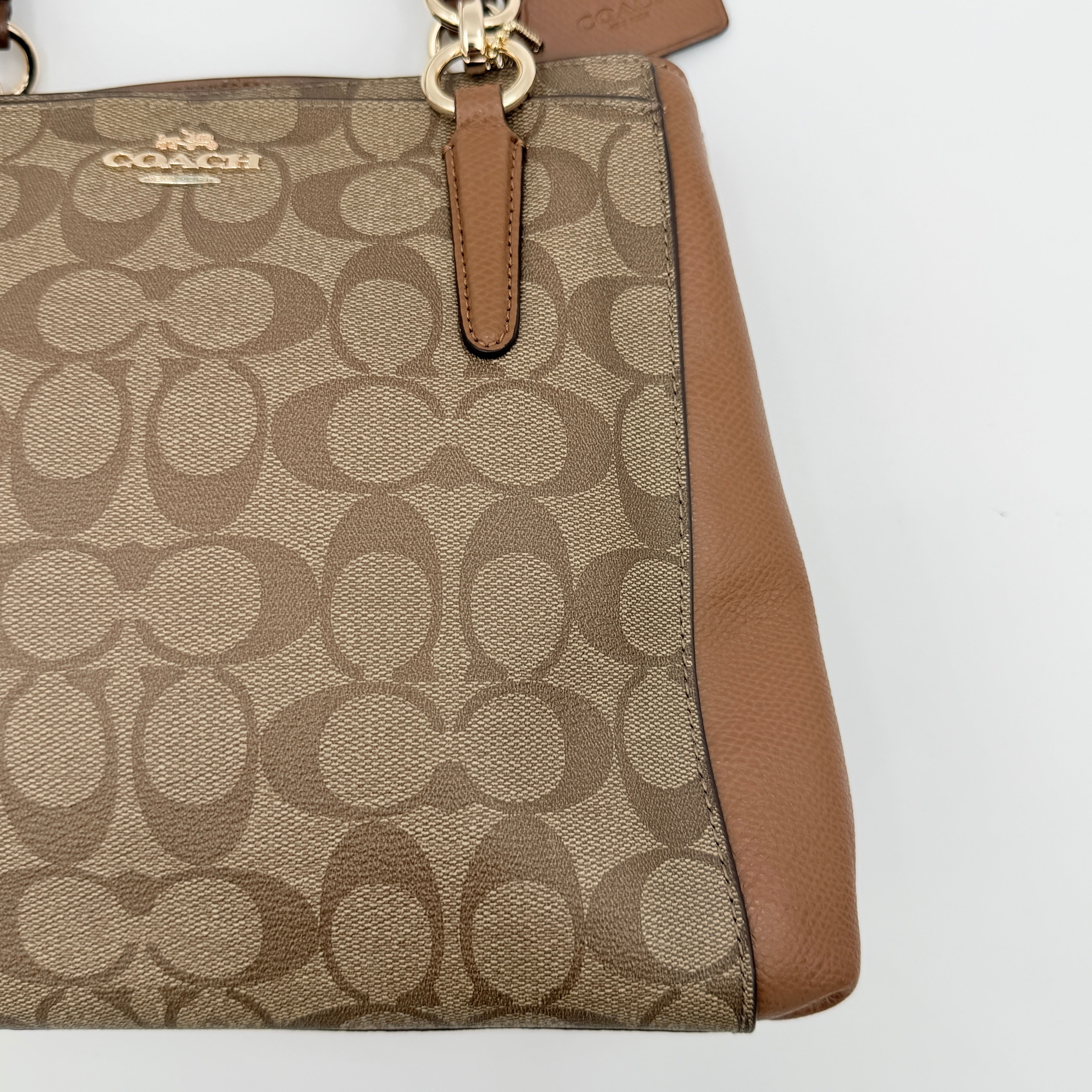 Coach Mini Christie Carryall in brown canvas and leather, shown with top handles and detachable strap.