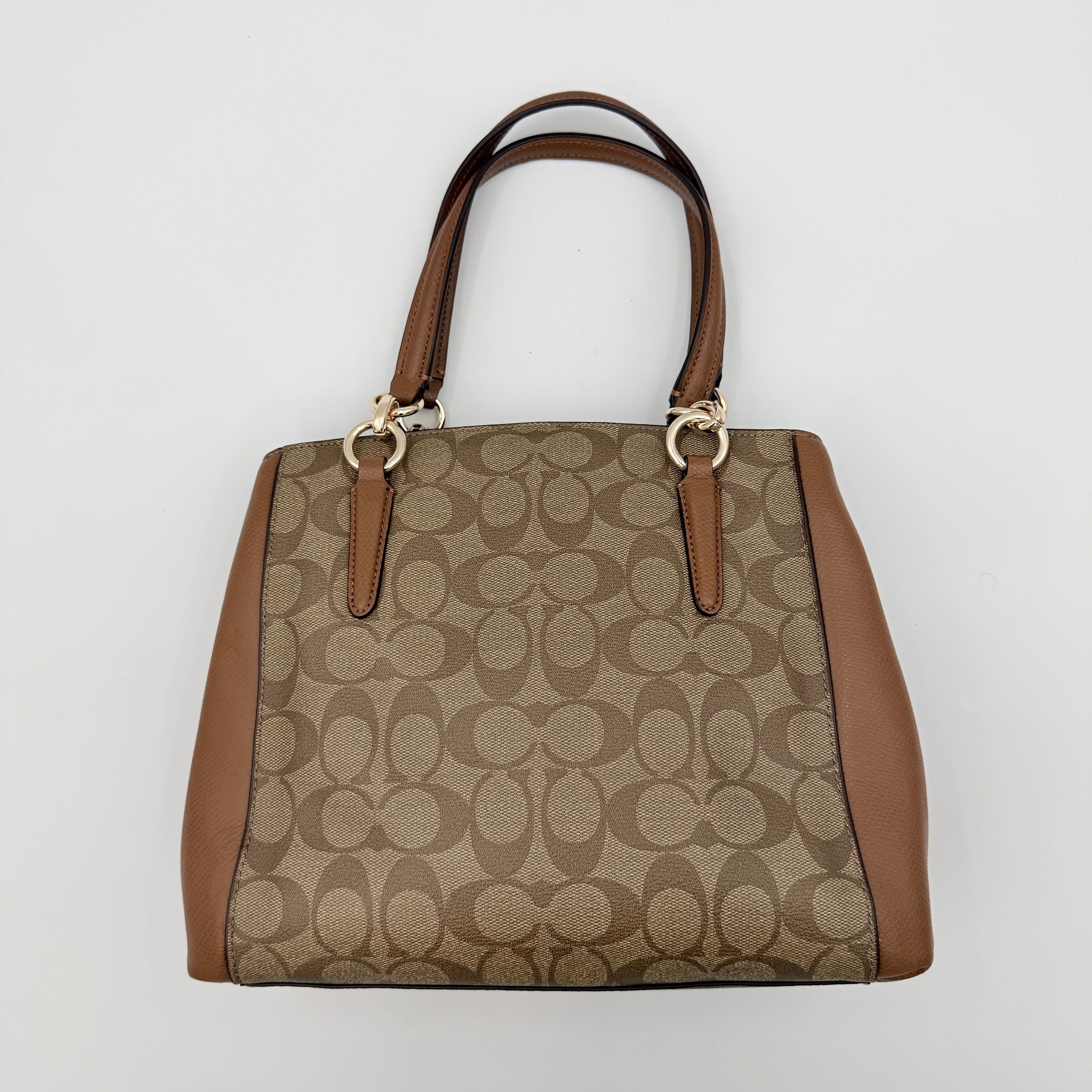 Coach Mini Christie Carryall in brown canvas and leather, shown with top handles and detachable strap.