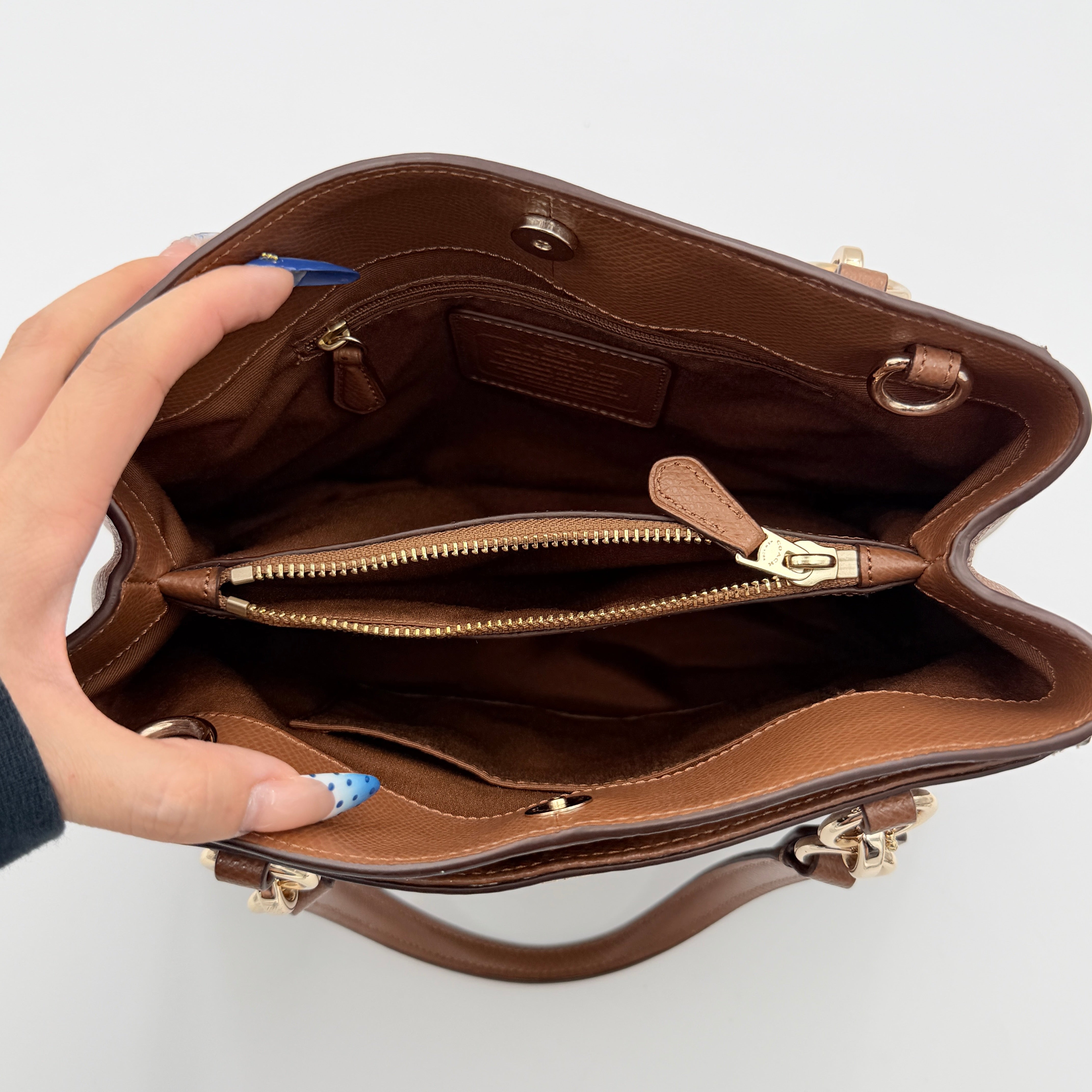 Coach Mini Christie Carryall in brown canvas and leather, shown with top handles and detachable strap.