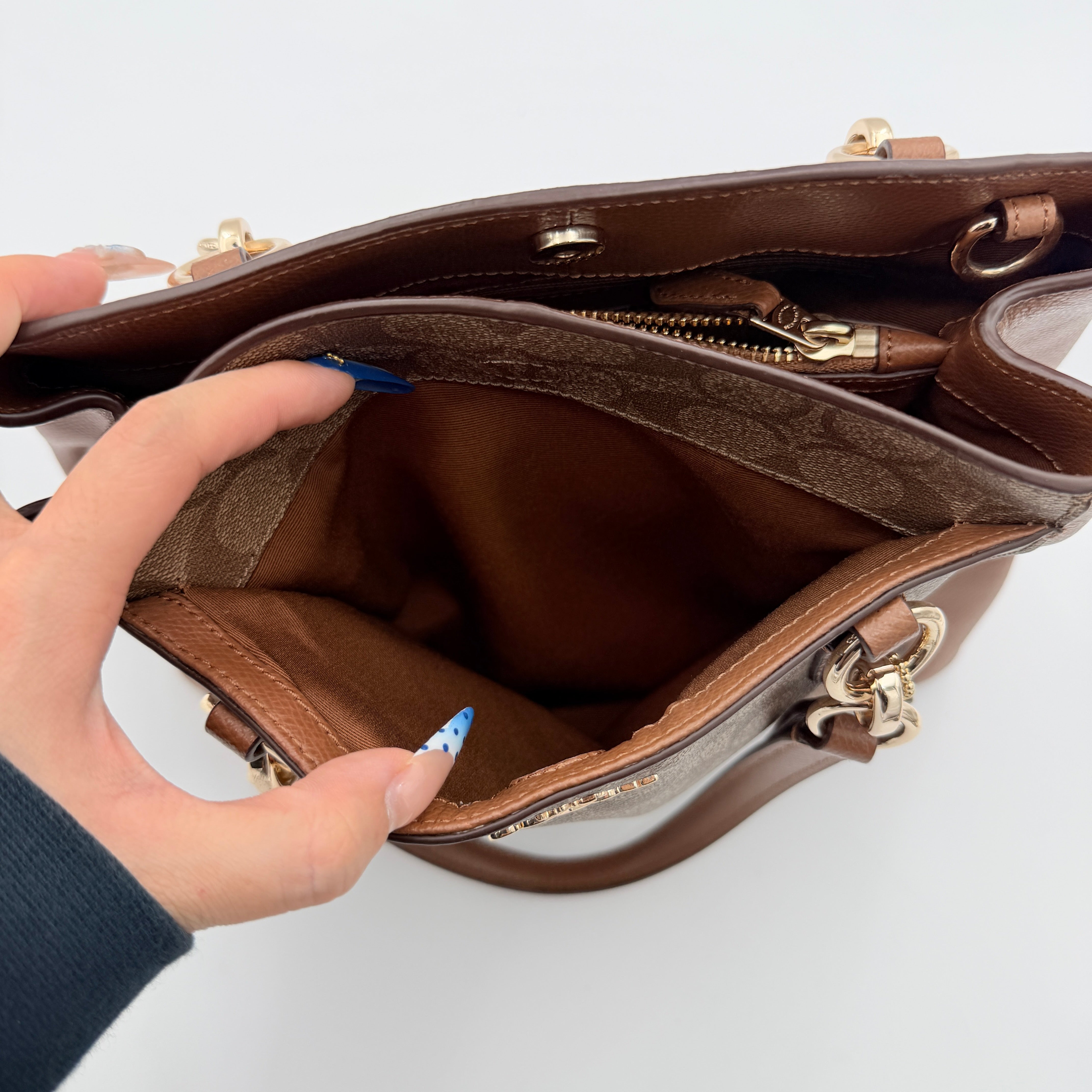 Coach Mini Christie Carryall in brown canvas and leather, shown with top handles and detachable strap.
