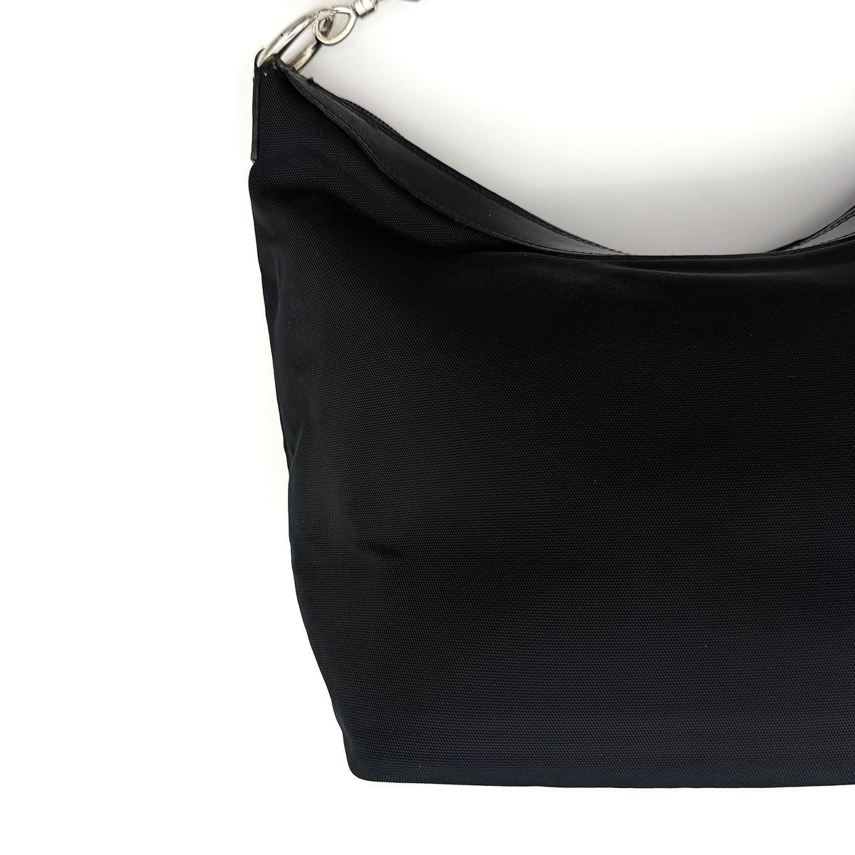 Gucci black nylon shoulder bag with bamboo handle and silver-tone hardware against a white background.