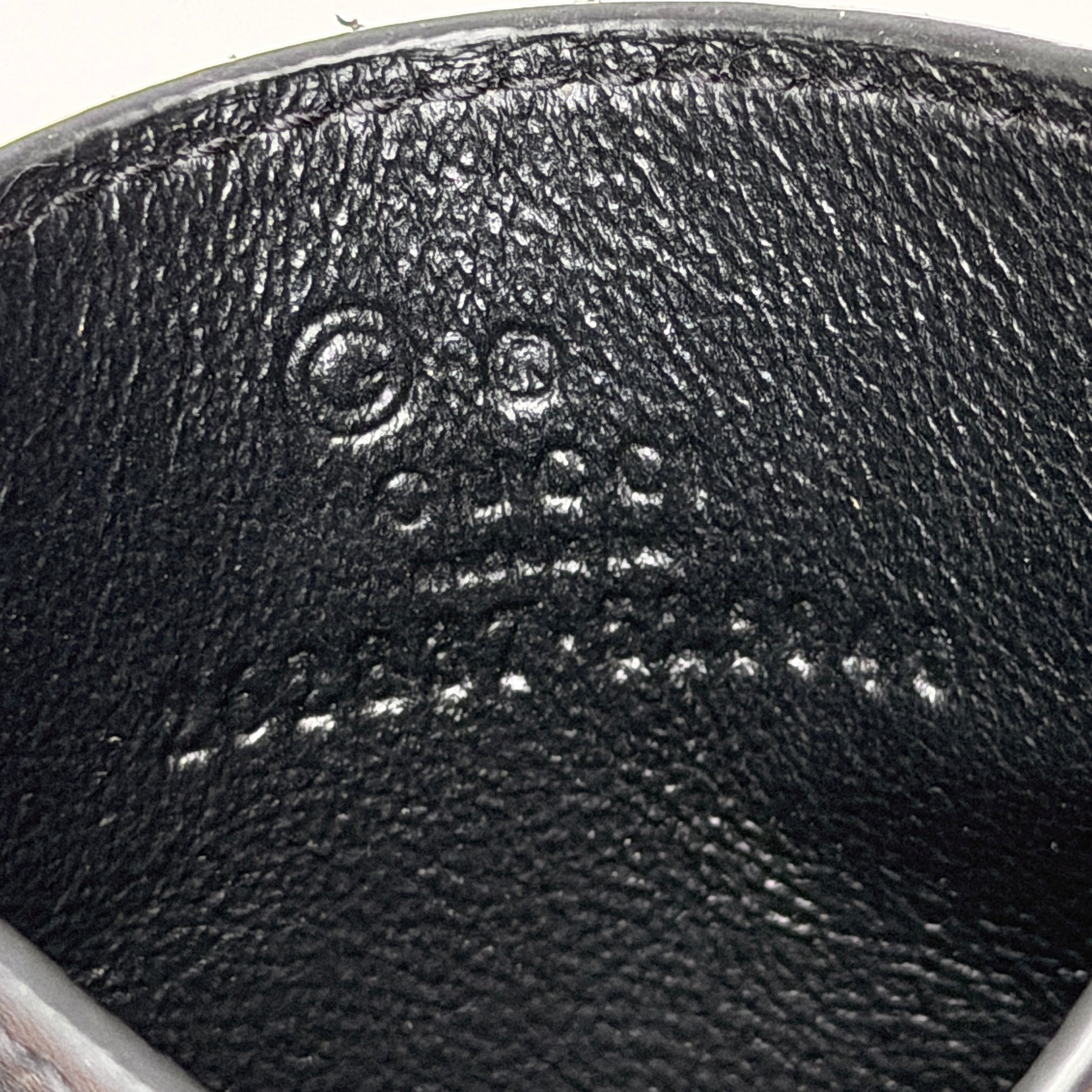 Gucci GG Microguccissima card holder in black leather with embossed micro GG motif, compact silhouette and refined finish.