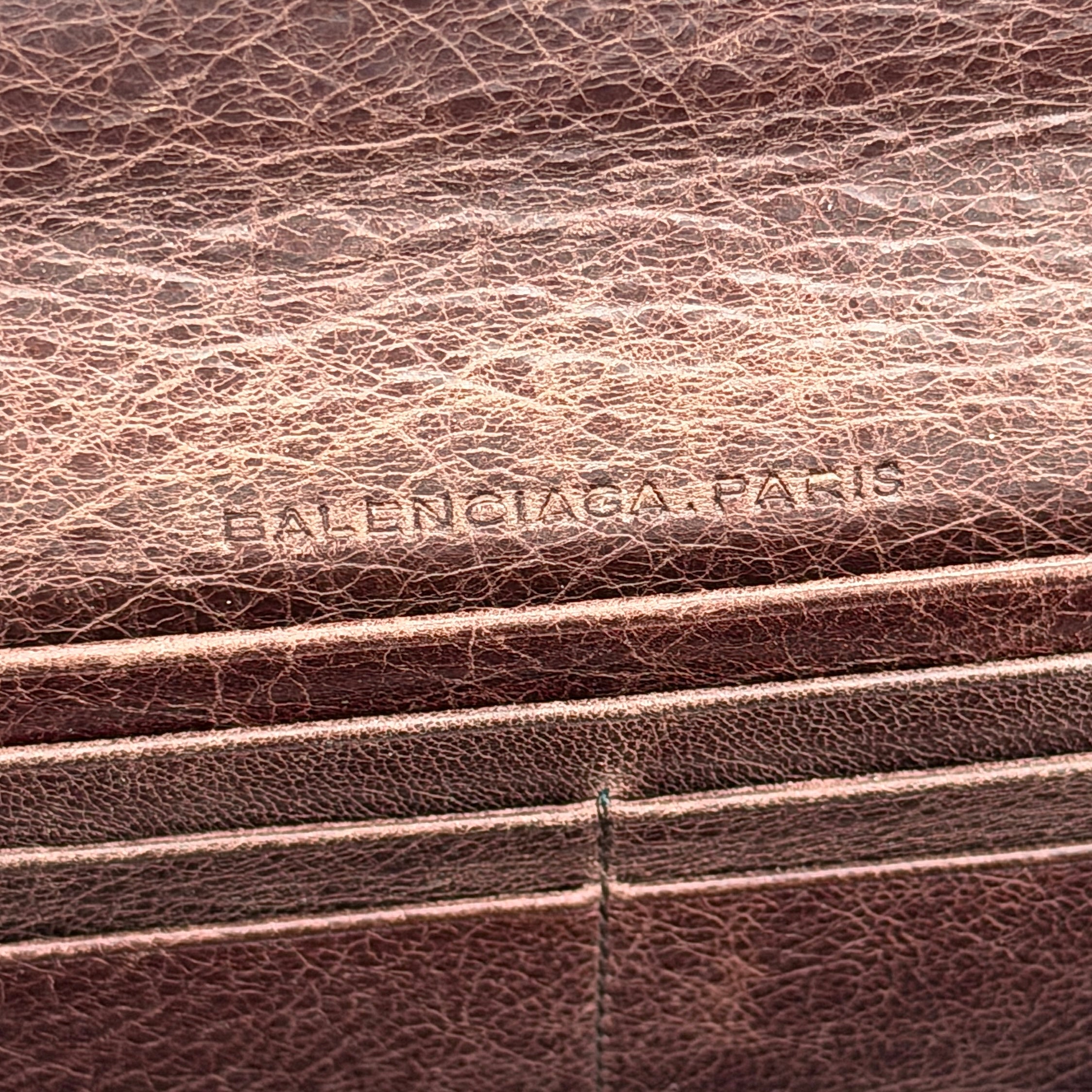 Balenciaga City Leather Long Wallet in brown distressed leather with signature buckle and zip detailing.