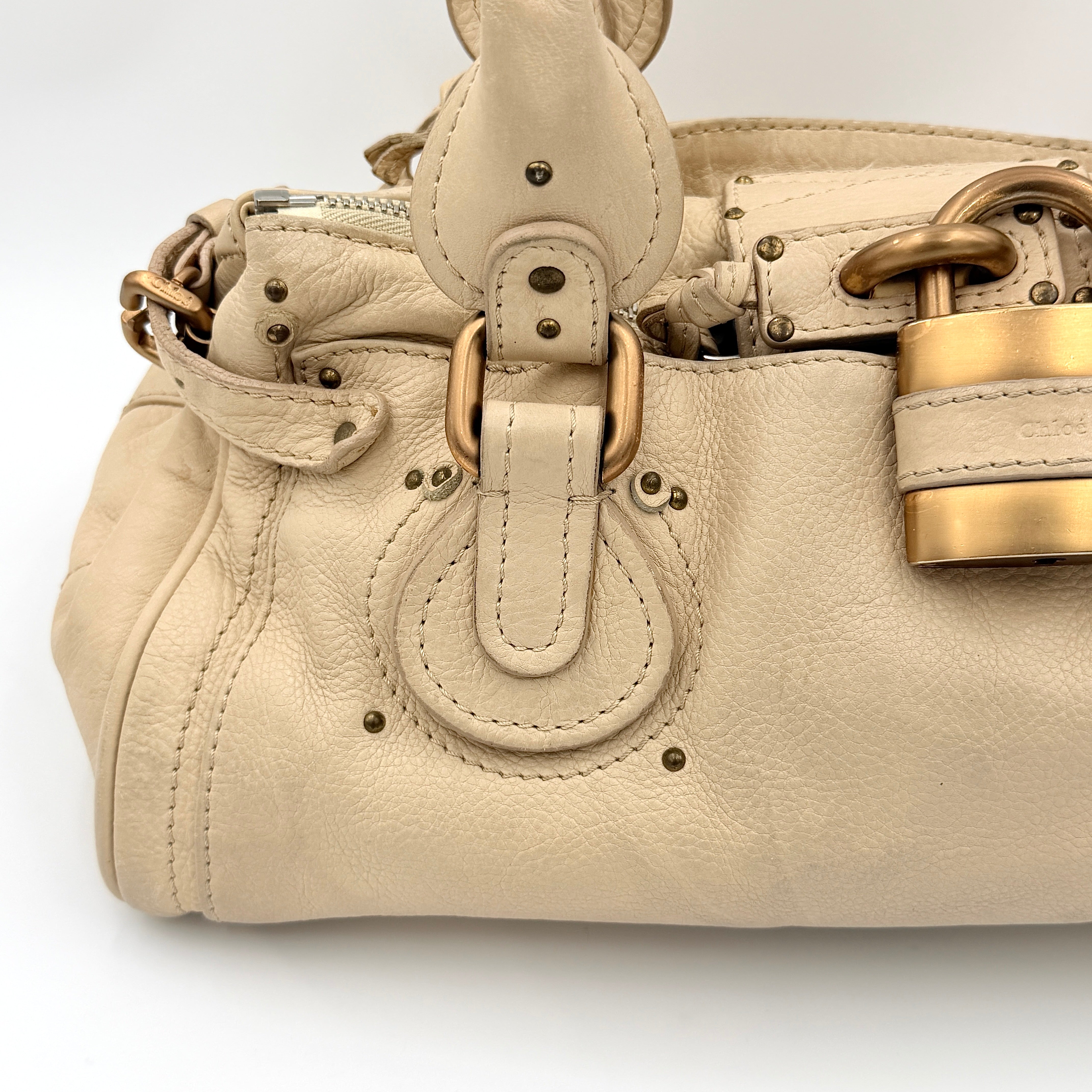 Chloé Paddington Shoulder Bag in ivory leather with signature brass padlock and double rolled handles.