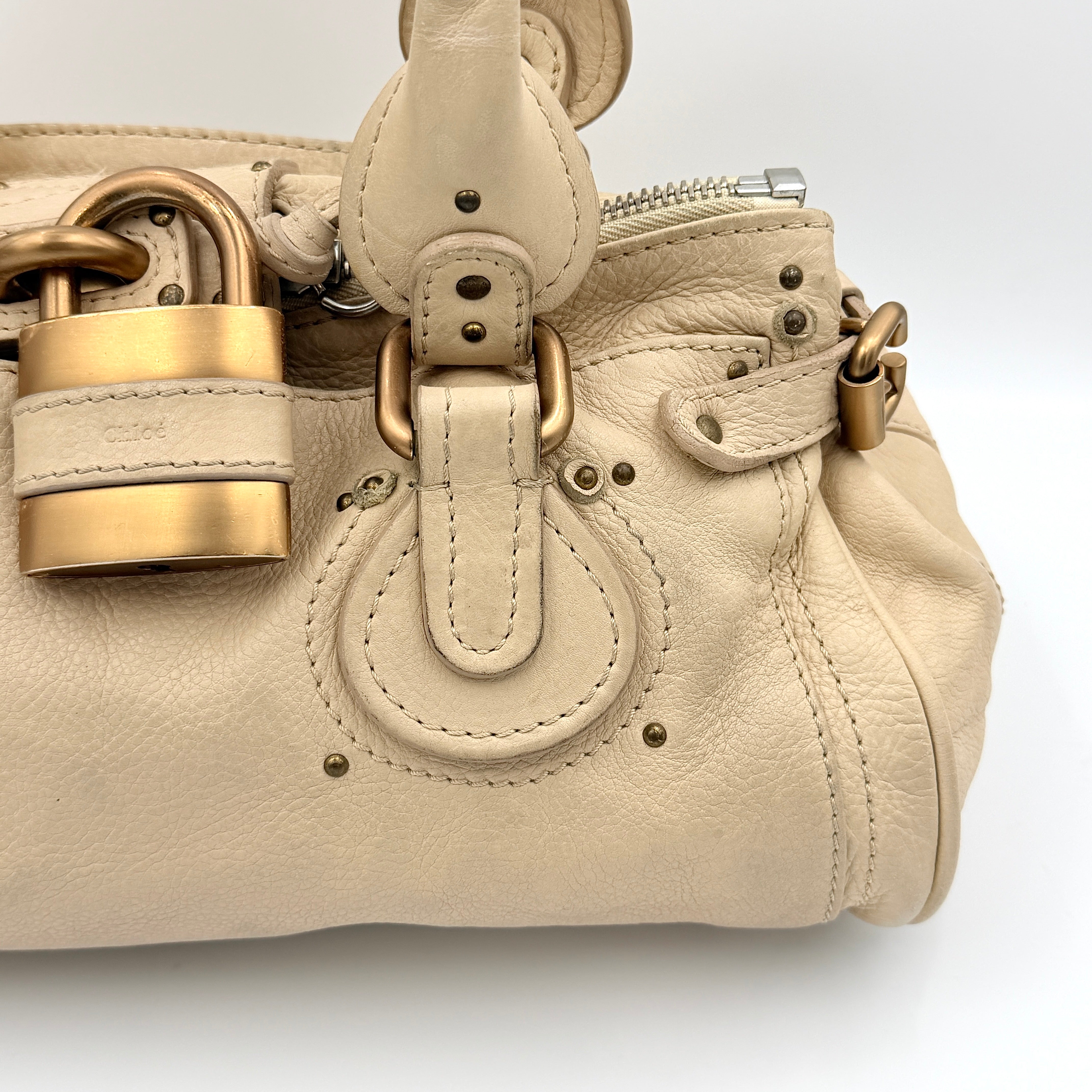 Chloé Paddington Shoulder Bag in ivory leather with signature brass padlock and double rolled handles.