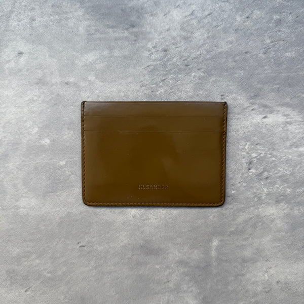 Jil Sander Brown Leather Cardholder with multiple slots and central slip pocket, slim minimalist design.