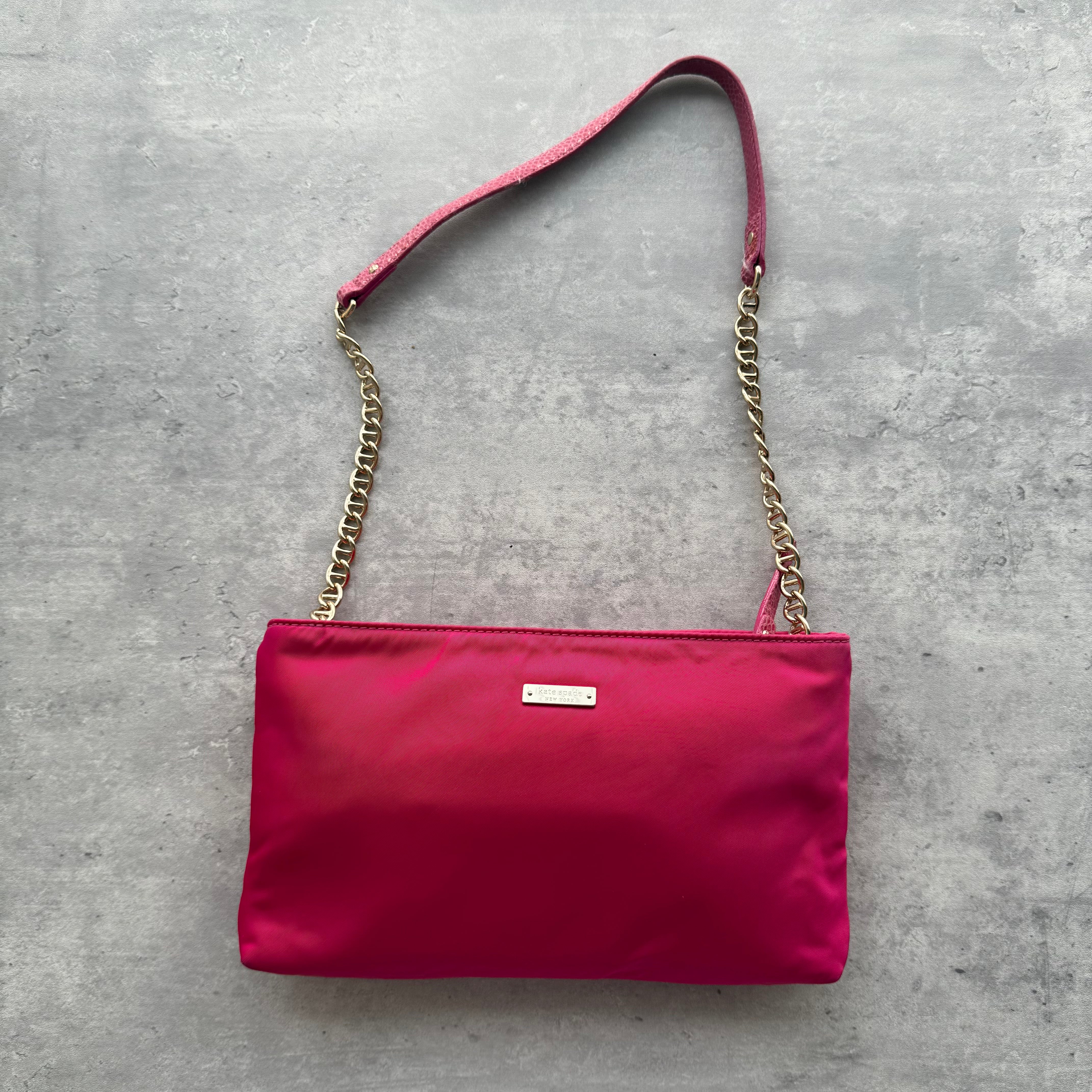 Kate Spade New York Shoulder Bag in pink fabric with bow detail, gold-tone chain strap, and logo plaque.