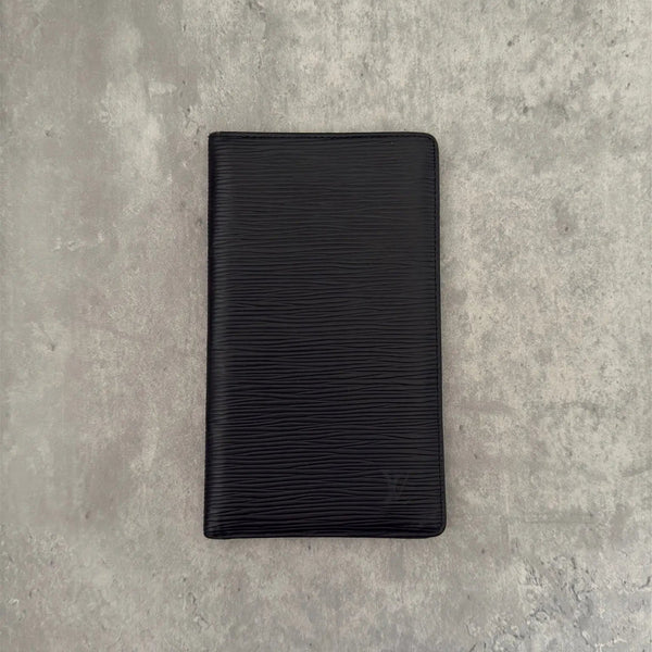 Louis Vuitton Porte Yen Cartes Credit Long Wallet in black Epi leather, featuring multiple card slots, a bill compartment, and LV embossed logo, epitomizing luxury and functionality.
