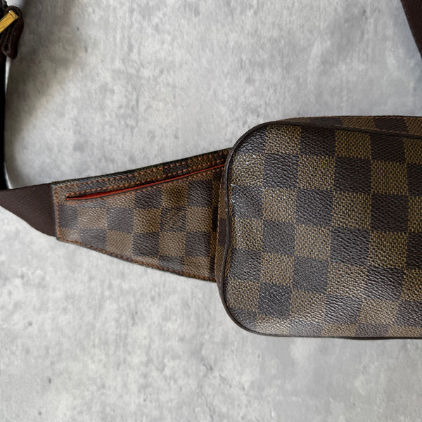 Louis Vuitton Geronimos Bag in brown Damier Ebene canvas with adjustable strap, red interior, and zip closure.