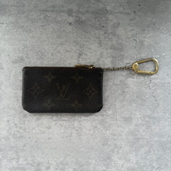 Louis Vuitton Monogram Coin Purse with gold-tone zipper and clasp, crafted in coated canvas with brown leather interior