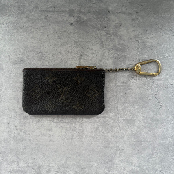 Louis Vuitton Monogram Coin Purse with gold-tone zipper and clasp, crafted in coated canvas with brown leather interior