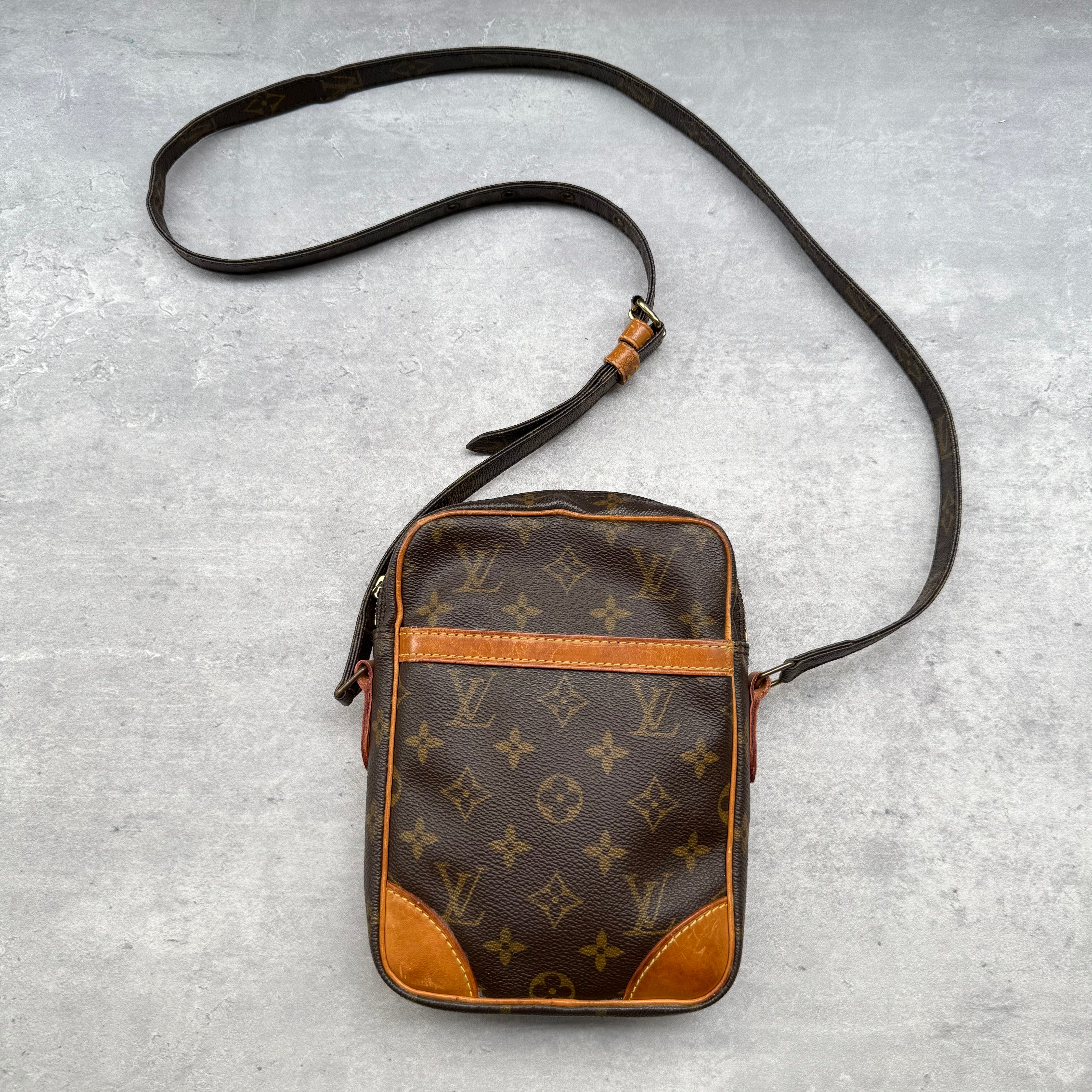 Louis Vuitton Monogram Danube Crossbody Bag in brown, crafted from monogram canvas with leather trim and gold-tone hardware.