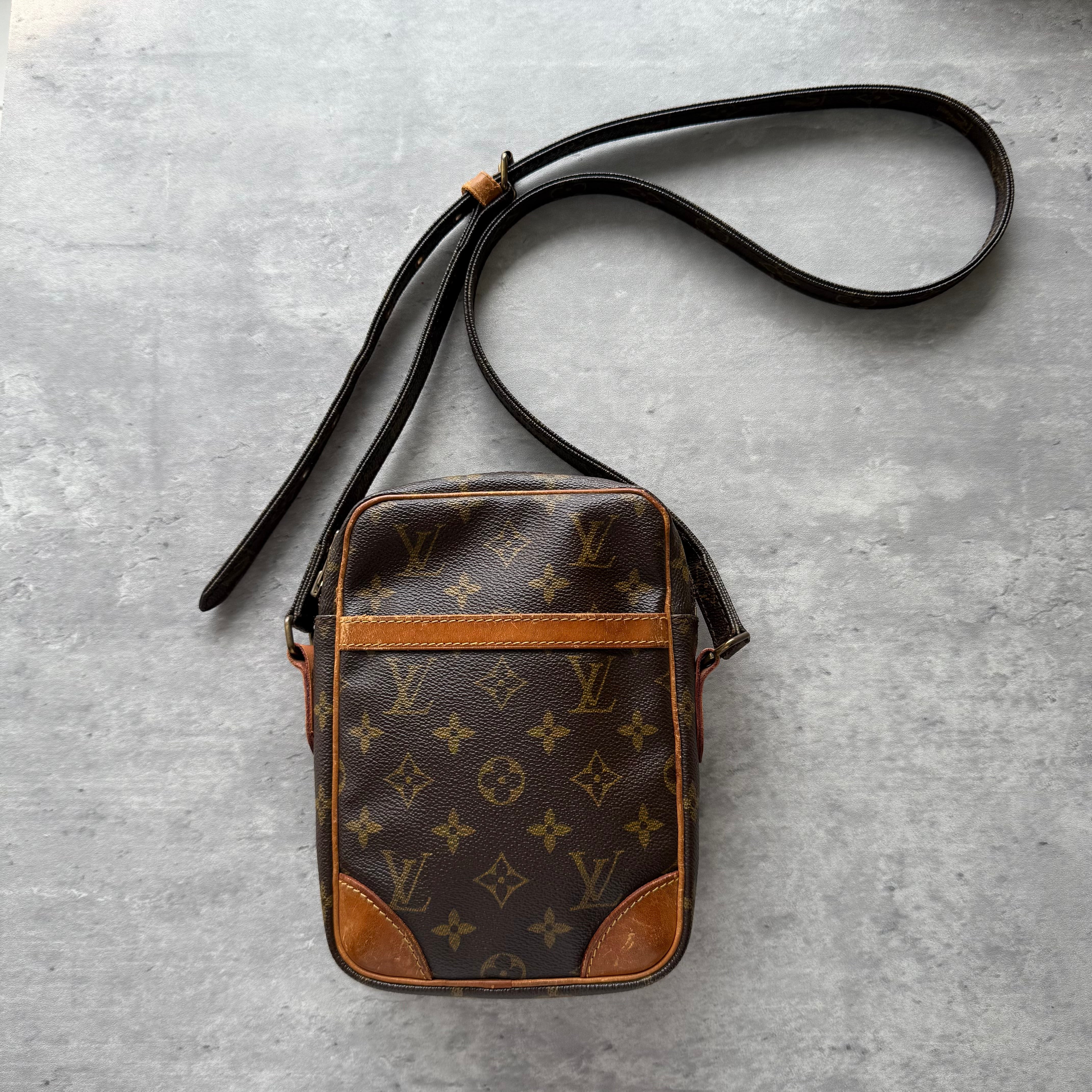 Louis Vuitton Monogram Danube Crossbody Bag Brown with adjustable leather strap, front slip pocket, and zip closure in classic monogram canvas.