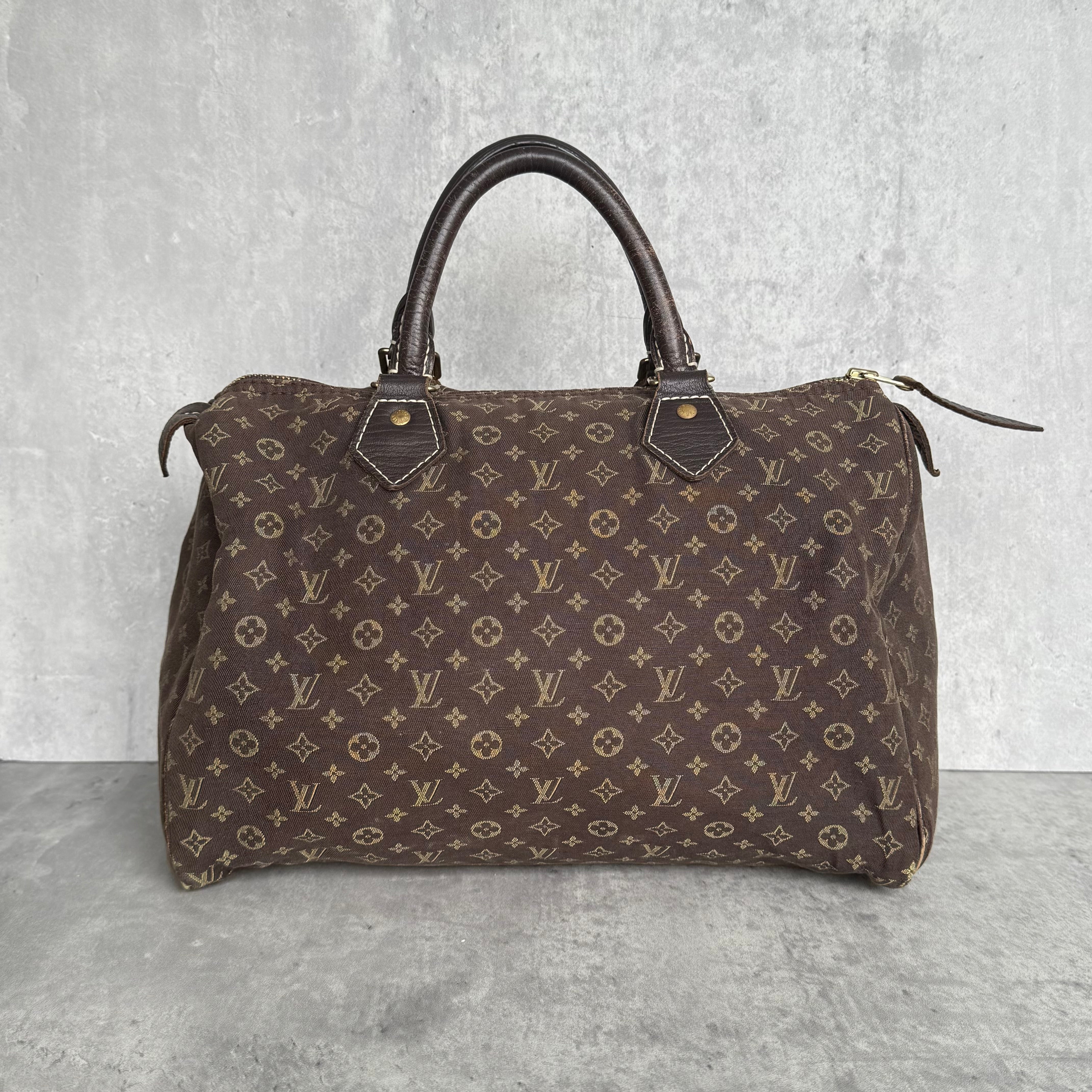 Louis Vuitton Monogram Mini Lin Speedy 30 Handbag in brown, crafted from linen-blend monogram fabric with leather trim.