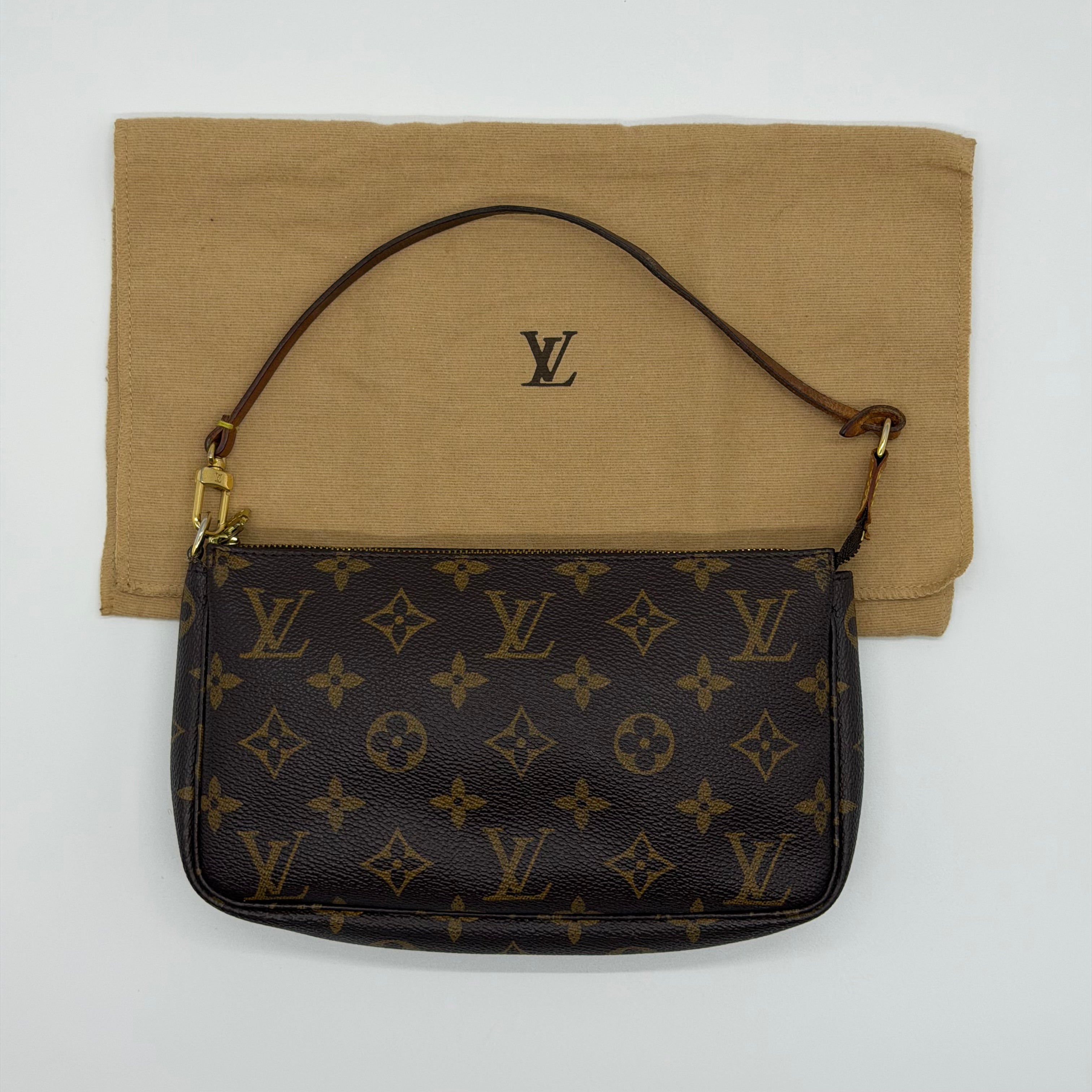 Louis Vuitton Monogram Pochette bag in brown coated canvas with leather strap and gold-tone zip — pre-loved.