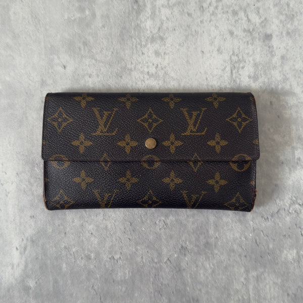 Luxurious Louis Vuitton Monogram Portefeuille Sarah Long Wallet, showcasing the iconic LV print and a spacious, organized interior, perfect for everyday sophistication.