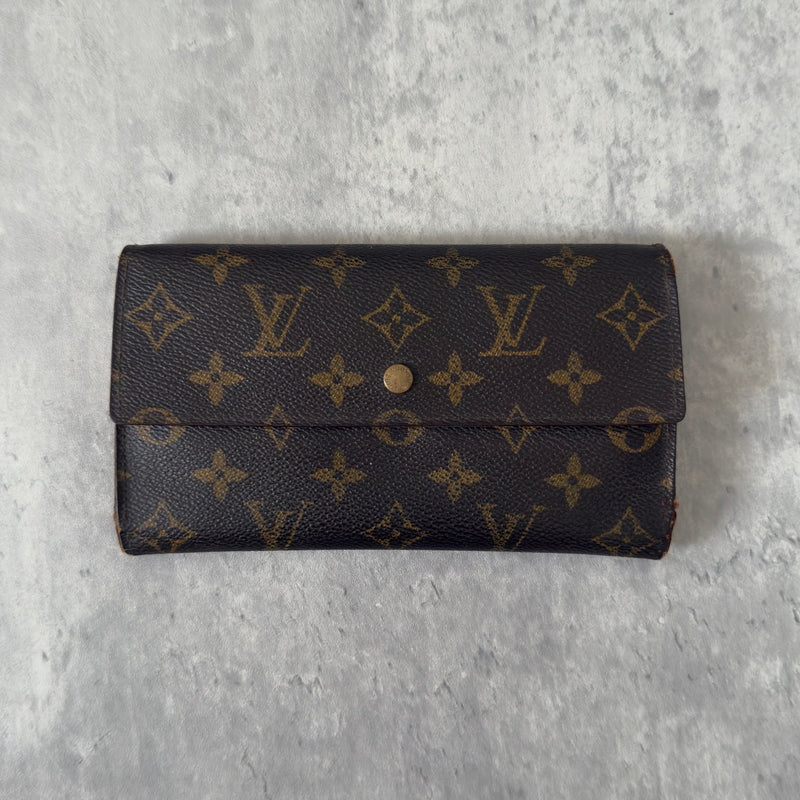 Luxurious Louis Vuitton Monogram Portefeuille Sarah Long Wallet, showcasing the iconic LV print and a spacious, organized interior, perfect for everyday sophistication.