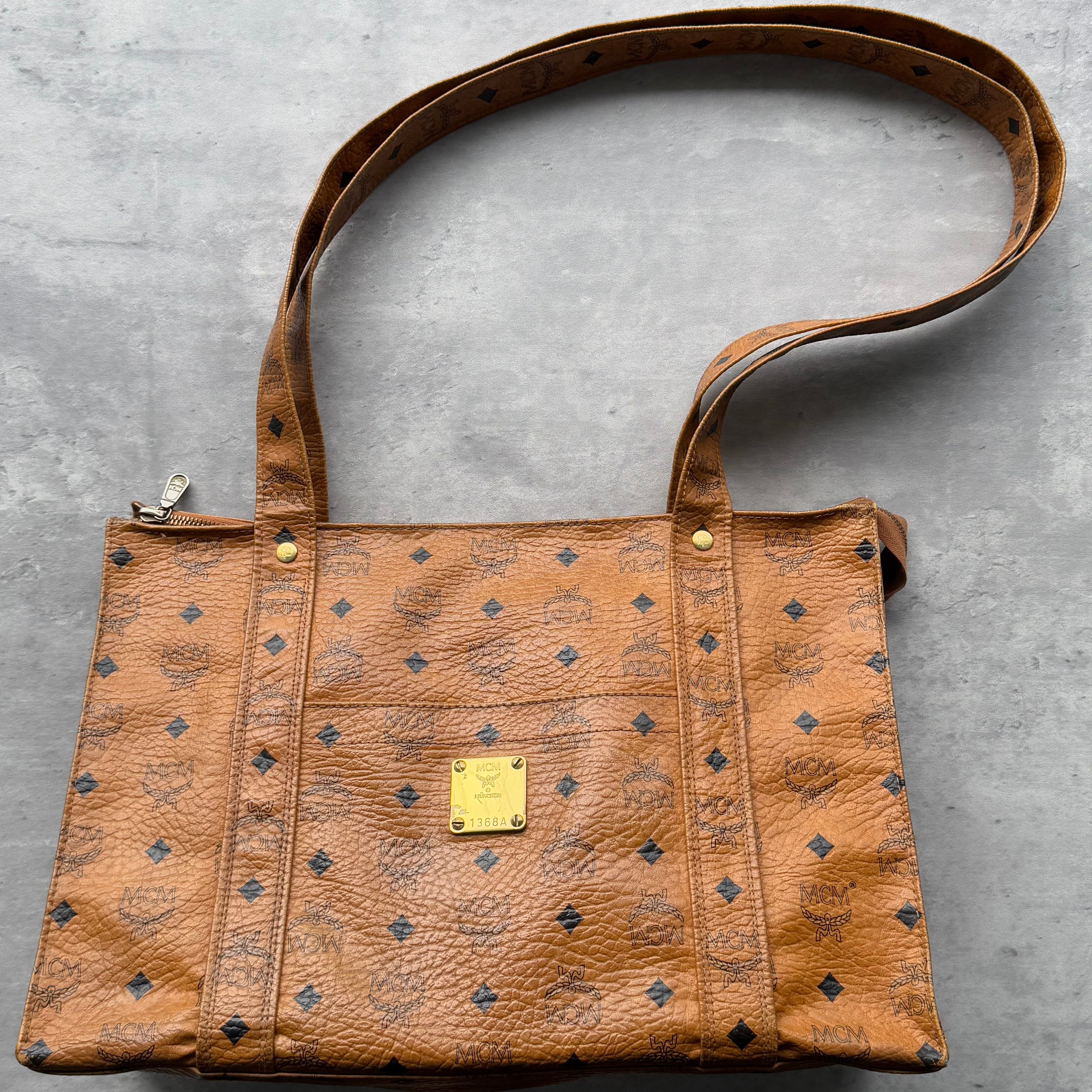 MCM Aren Visetos School Tote Bag in Cognac, crafted from monogram coated canvas with dual long straps and gold-tone logo plate.