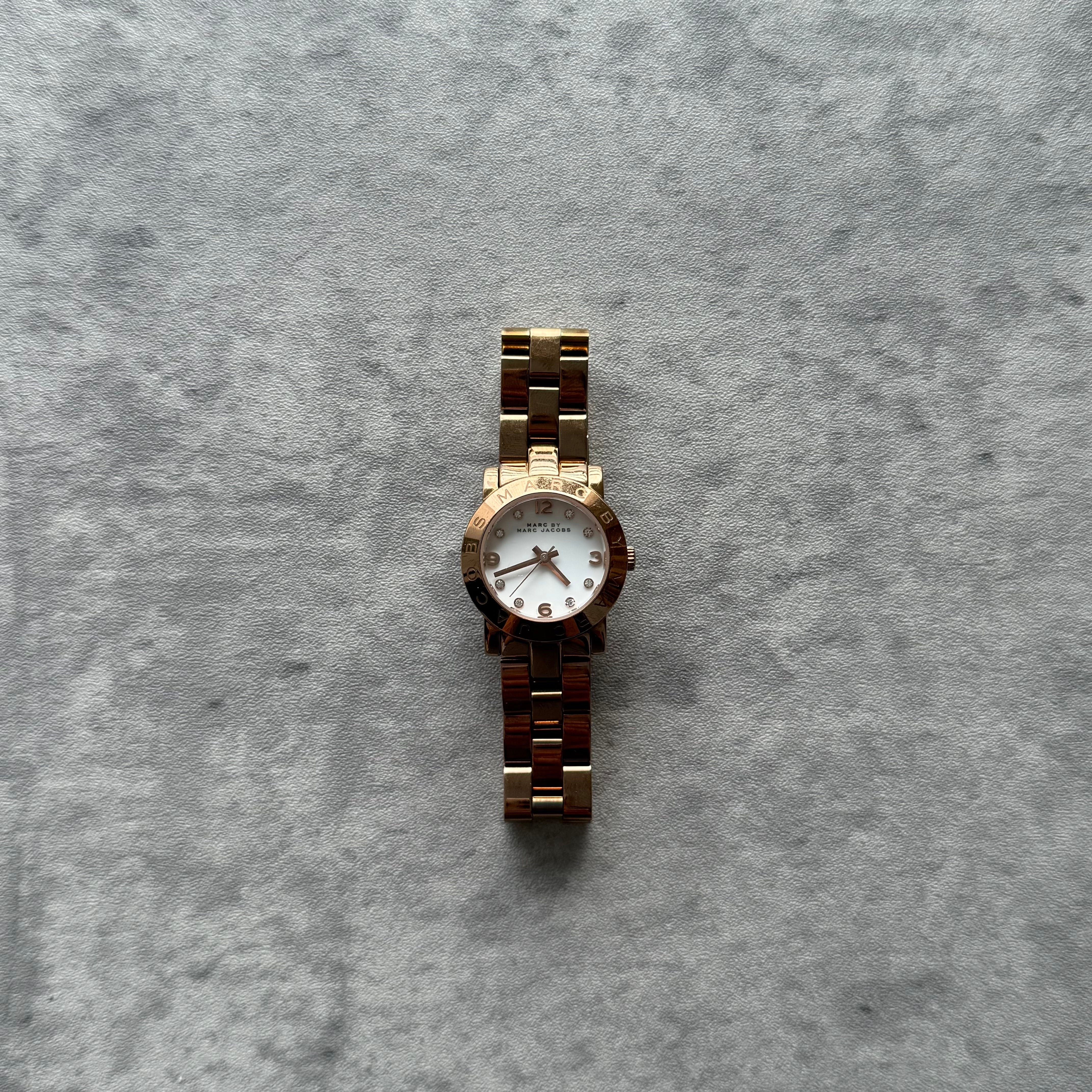 Marc Jacobs Mini Amy Watch in rose gold-tone stainless steel with white dial and crystal hour markers.