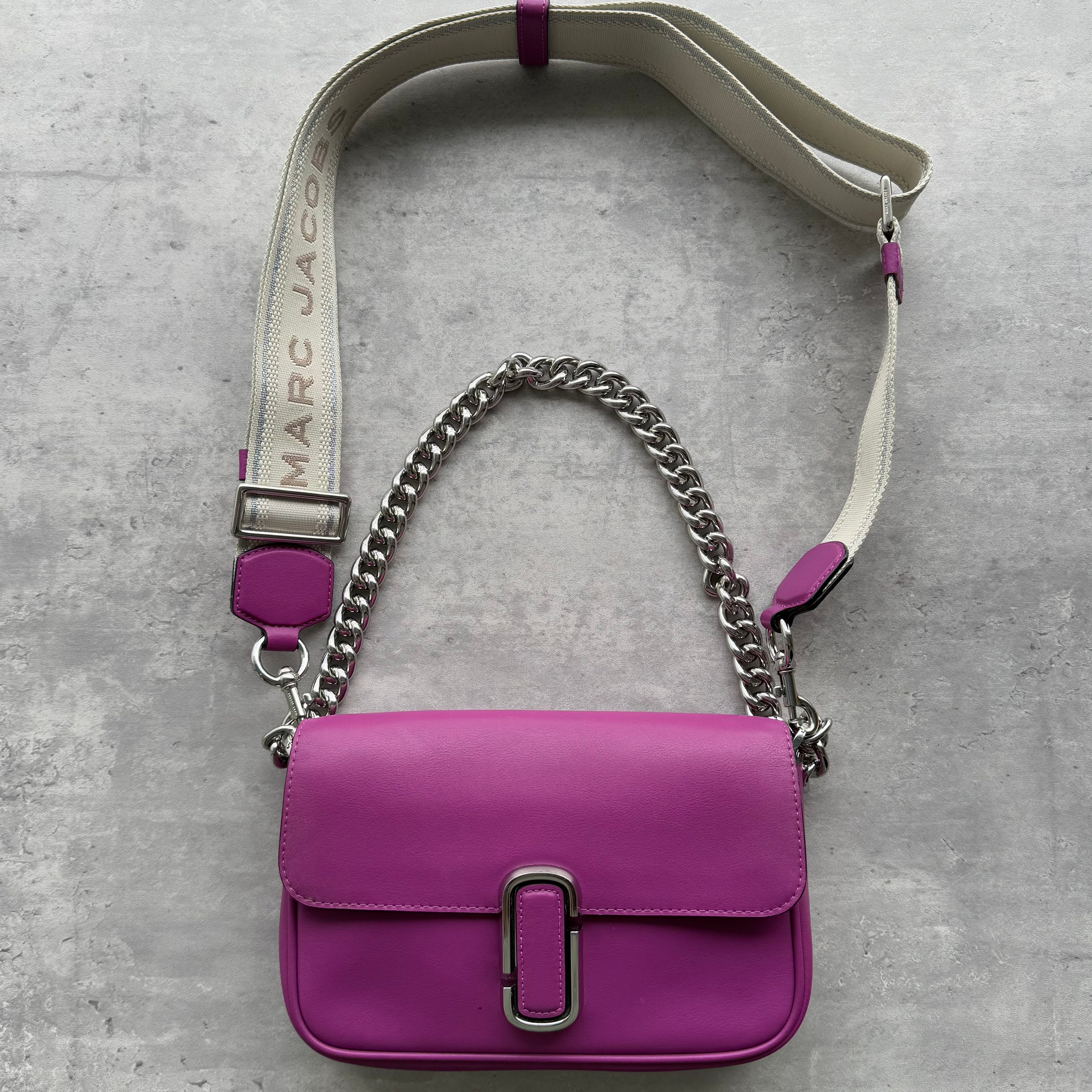 Marc Jacobs The J Marc Shoulder Bag in purple leather with silver hardware, chain handle, wide detachable logo strap, and flap closure.