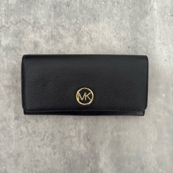 Michael Kors MK Gold Logo Bifold Long Wallet in black pebbled leather, featuring a structured silhouette with a gold-tone MK logo and a snap button closure.