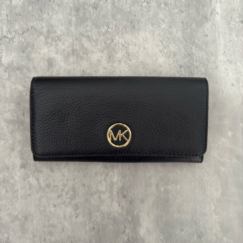Michael Kors MK Gold Logo Bifold Long Wallet in black pebbled leather, featuring a structured silhouette with a gold-tone MK logo and a snap button closure.