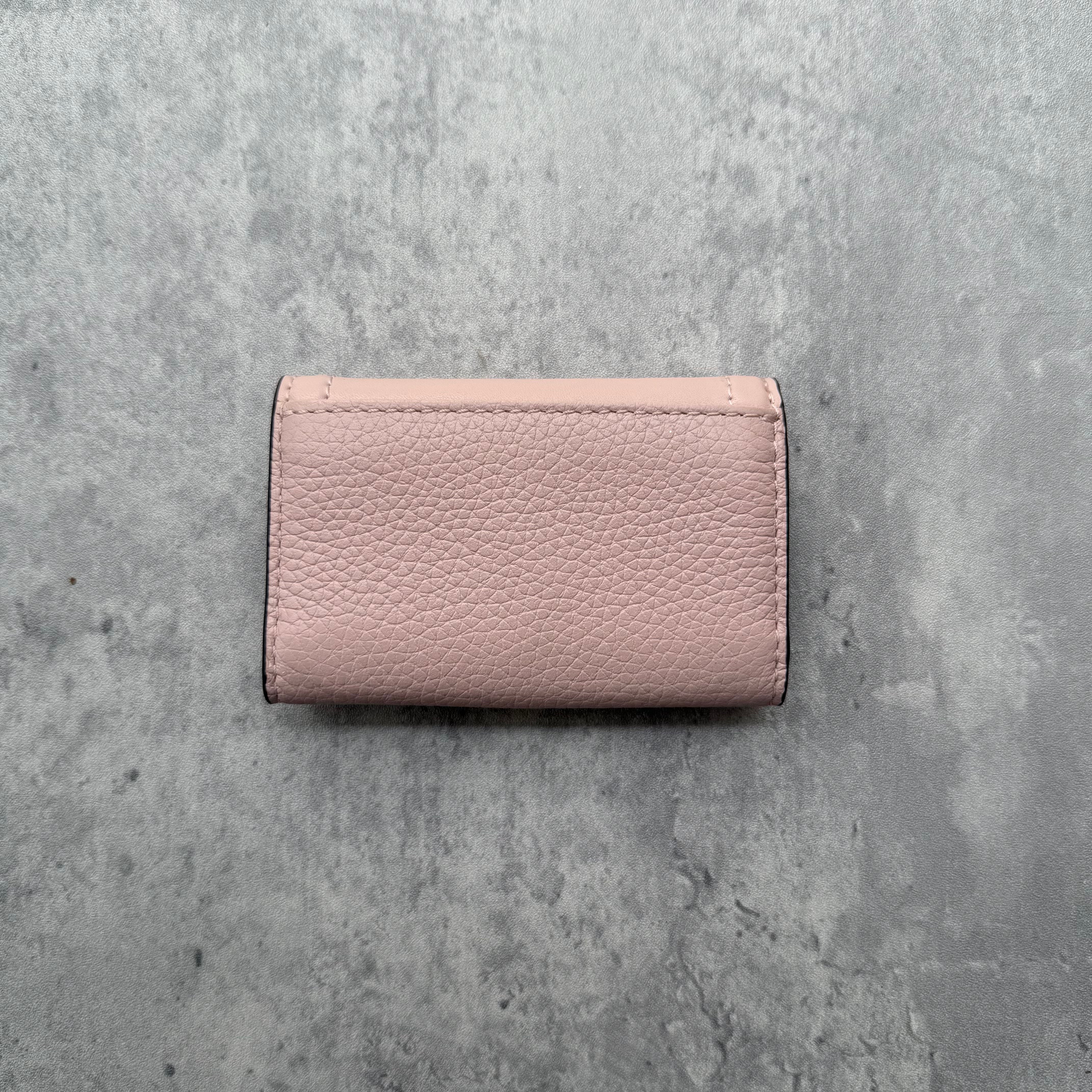 Michael Kors Pink Key Holder in pebbled leather with gold MK logo snap closure and interior key hooks.