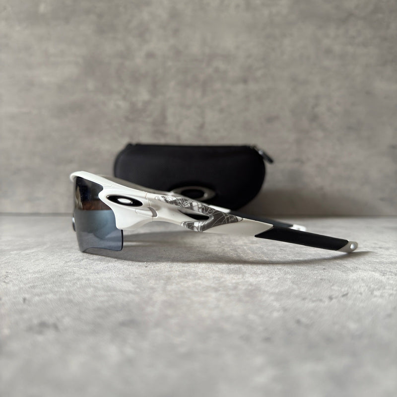 Oakley Prizm Radarlock Path sunglasses with white frame and Prizm lenses, showcasing advanced color and contrast enhancement technology for superior clarity in sports performance.