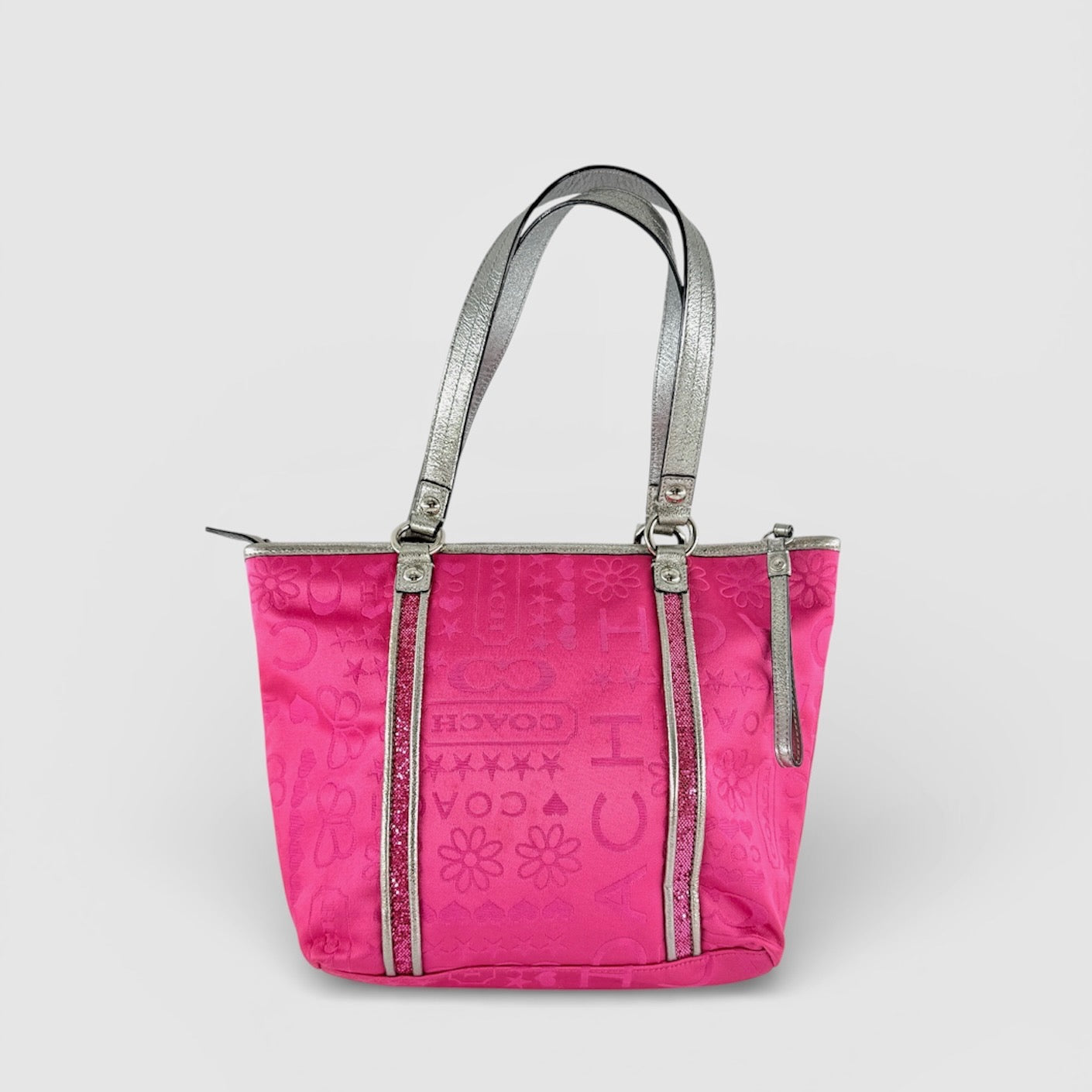 Coach Poppy Bandana Glitter Graffiti Tote Bag in vibrant pink with metallic silver handles, adorned with glitter accents and butterfly charm.