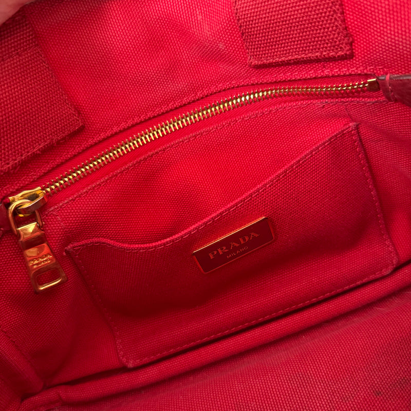 Prada Canapa Tote Bag in red canvas with black logo embroidery, featuring a structured silhouette and dual top handles for effortless style.