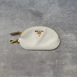 Prada Saffiano Coin Purse in white leather with gold-tone logo and clasp, featuring zip closure and monogram-lined interior.
