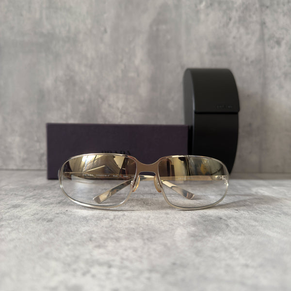Prada Transparent Silver Vintage Sunglasses with a sleek titanium frame and clear gradient lenses, featuring an engraved Prada logo on the temples.