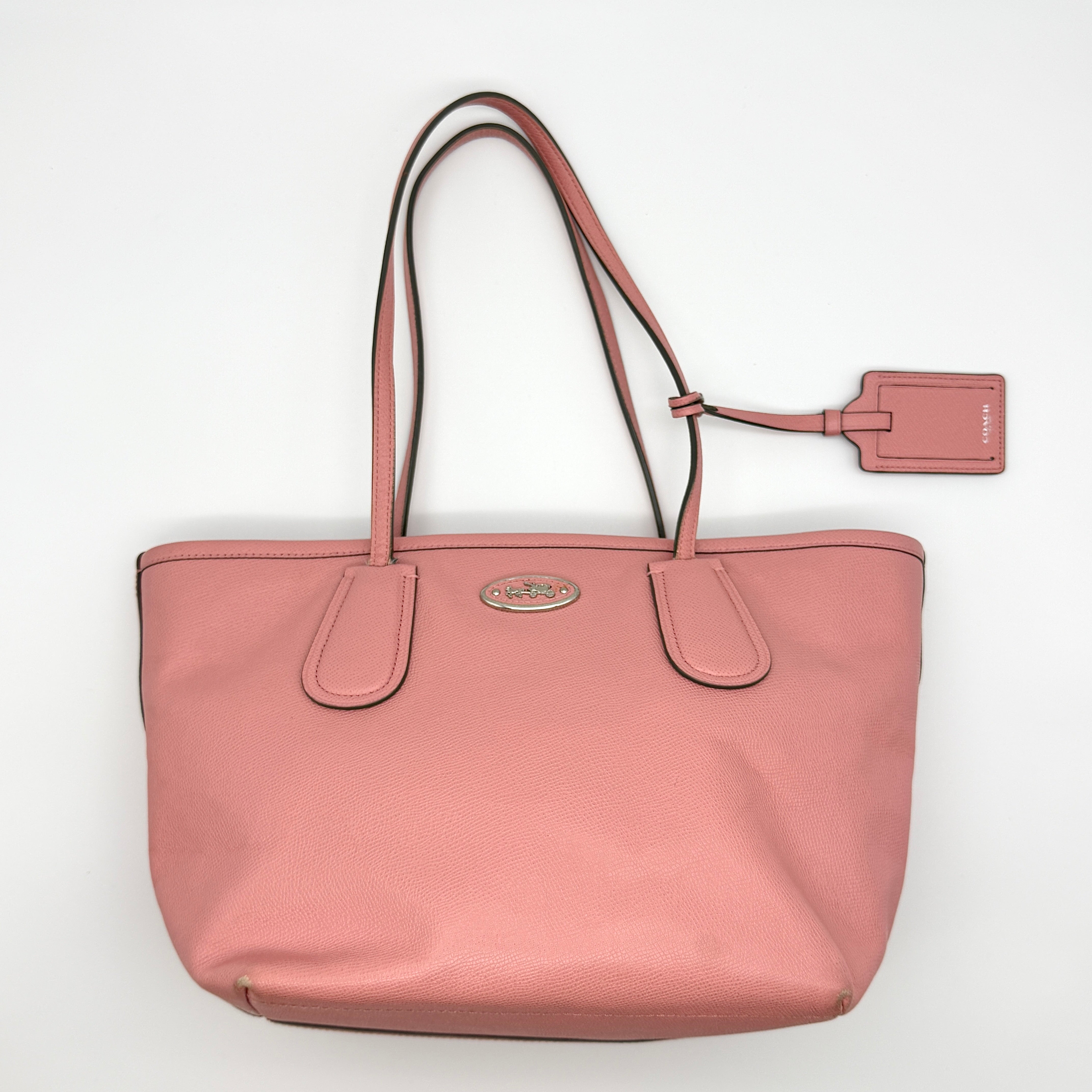 Coach Taxi Zip Top Tote Bag Pink, crafted from textured pebbled leather with silver-tone logo plaque and matching pink hangtag