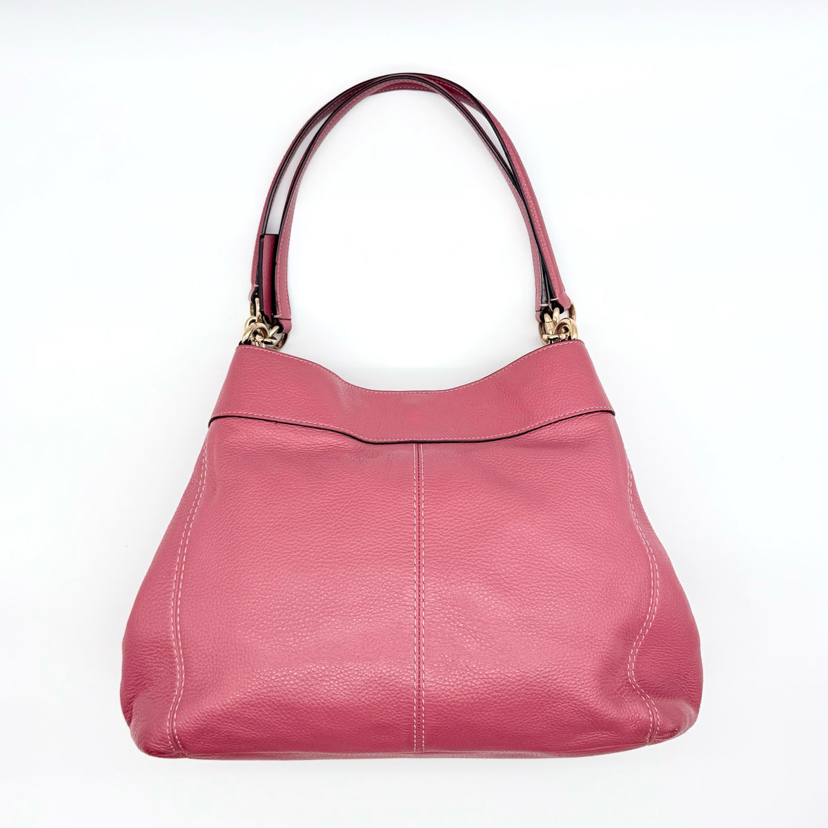 Coach Lexy Shoulder Bag in pink pebbled leather with gold hardware and dual straps, shown against a white background.