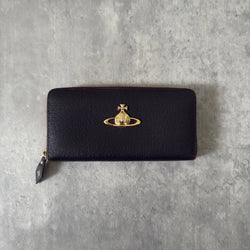 Vivienne Westwood Seditionaries Wallet, black leather, featuring the iconic gold-tone Orb emblem and a zip-around closure, interior detailed with brand's signature pattern.
