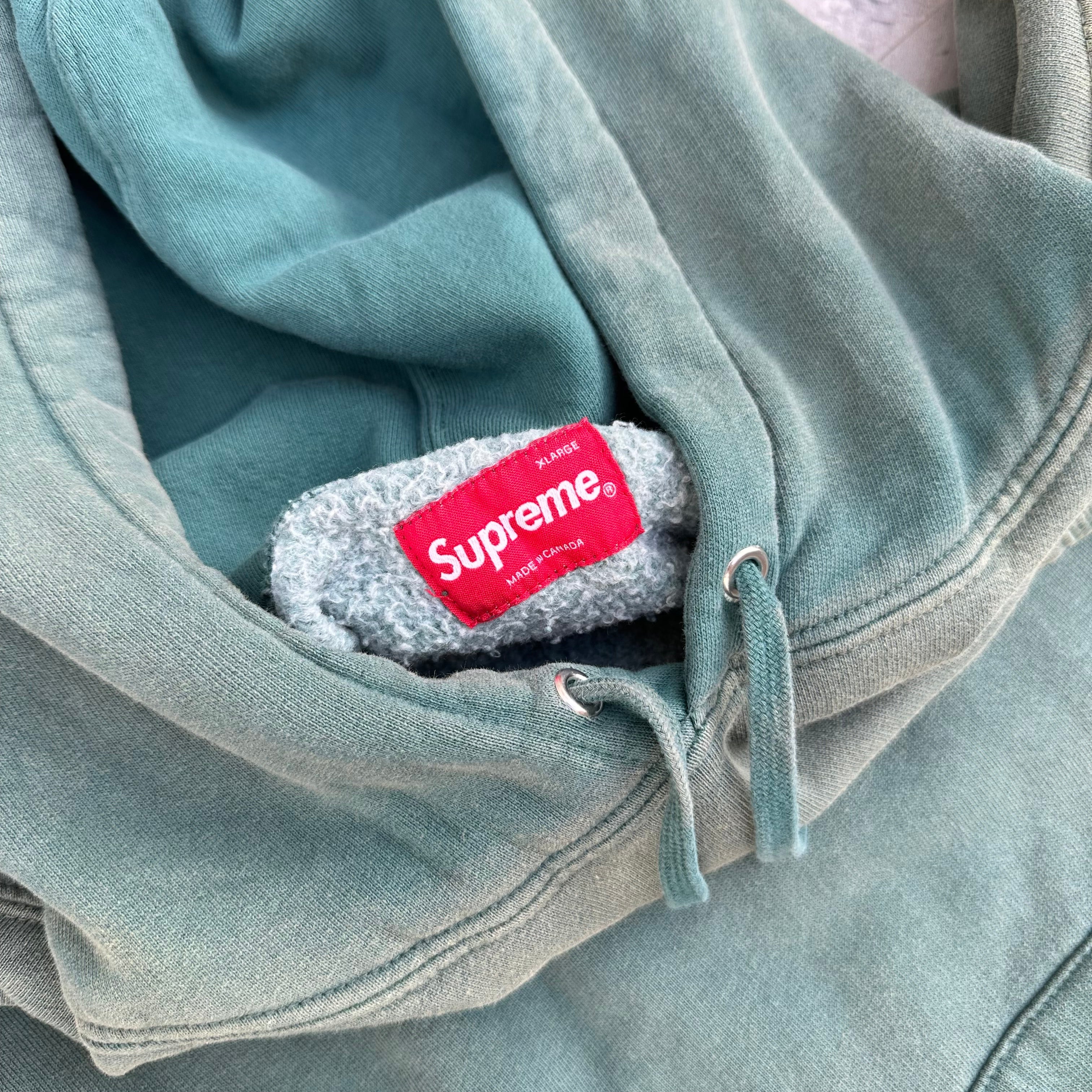 Supreme Overdyed S Logo Hoodie in washed teal, featuring tonal embroidered S on chest with kangaroo pocket and ribbed detailing