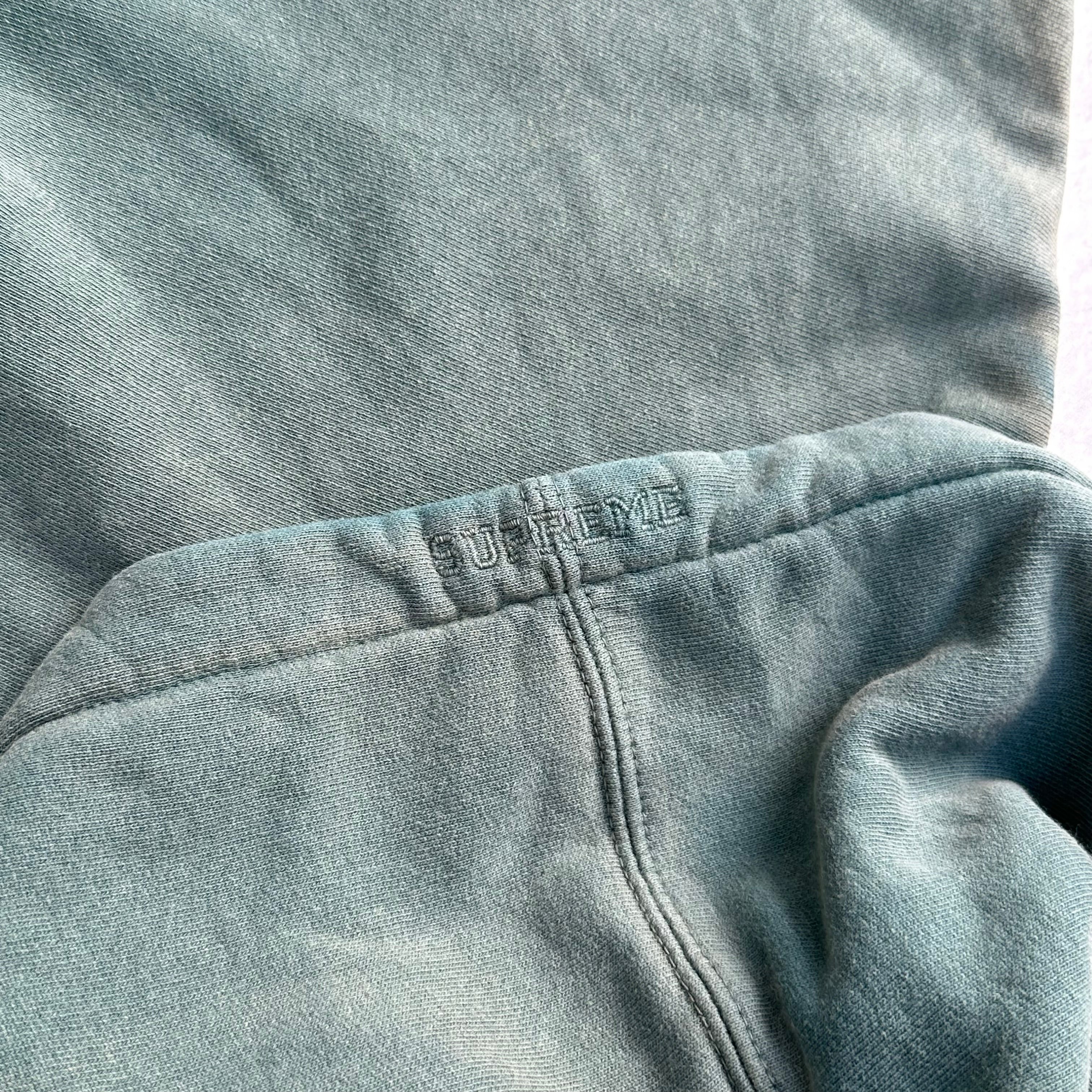 Supreme Overdyed S Logo Hoodie in washed teal, featuring tonal embroidered S on chest with kangaroo pocket and ribbed detailing