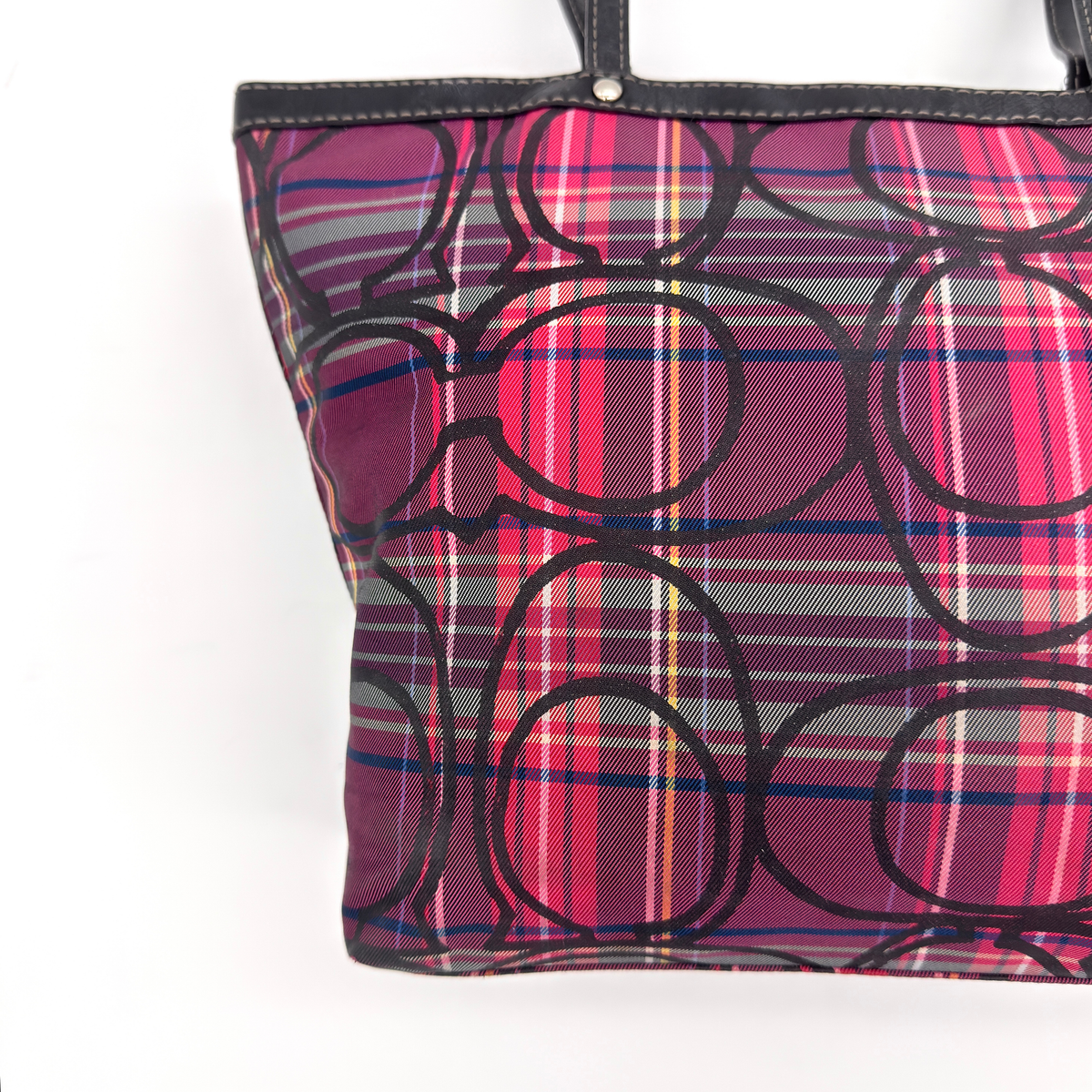 Coach Signature Poppy Tartan Plaid Tote Bag in vibrant multi-coloured plaid with black leather trim and oversized signature motif.