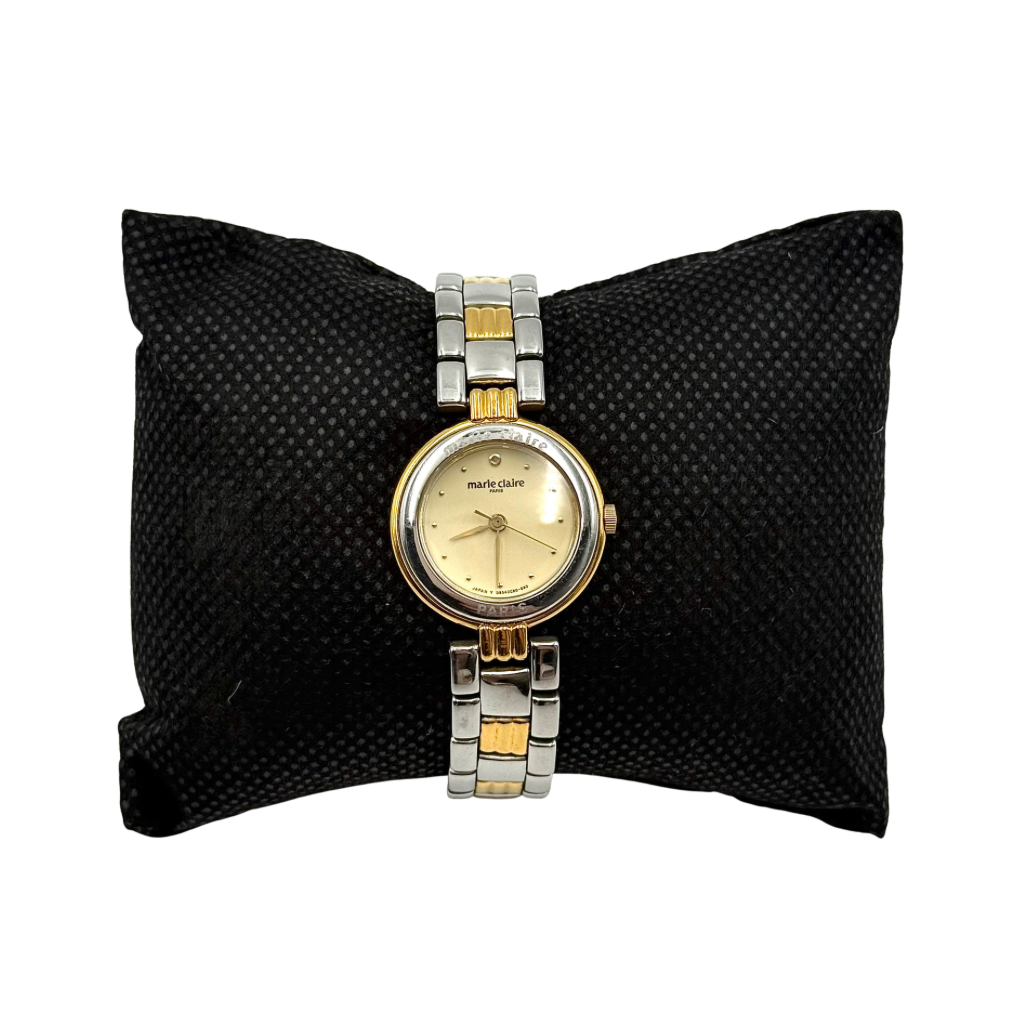 Marie Claire Paris 085268-00 two-tone gold and silver watch with a champagne dial, shown on a black pillow.