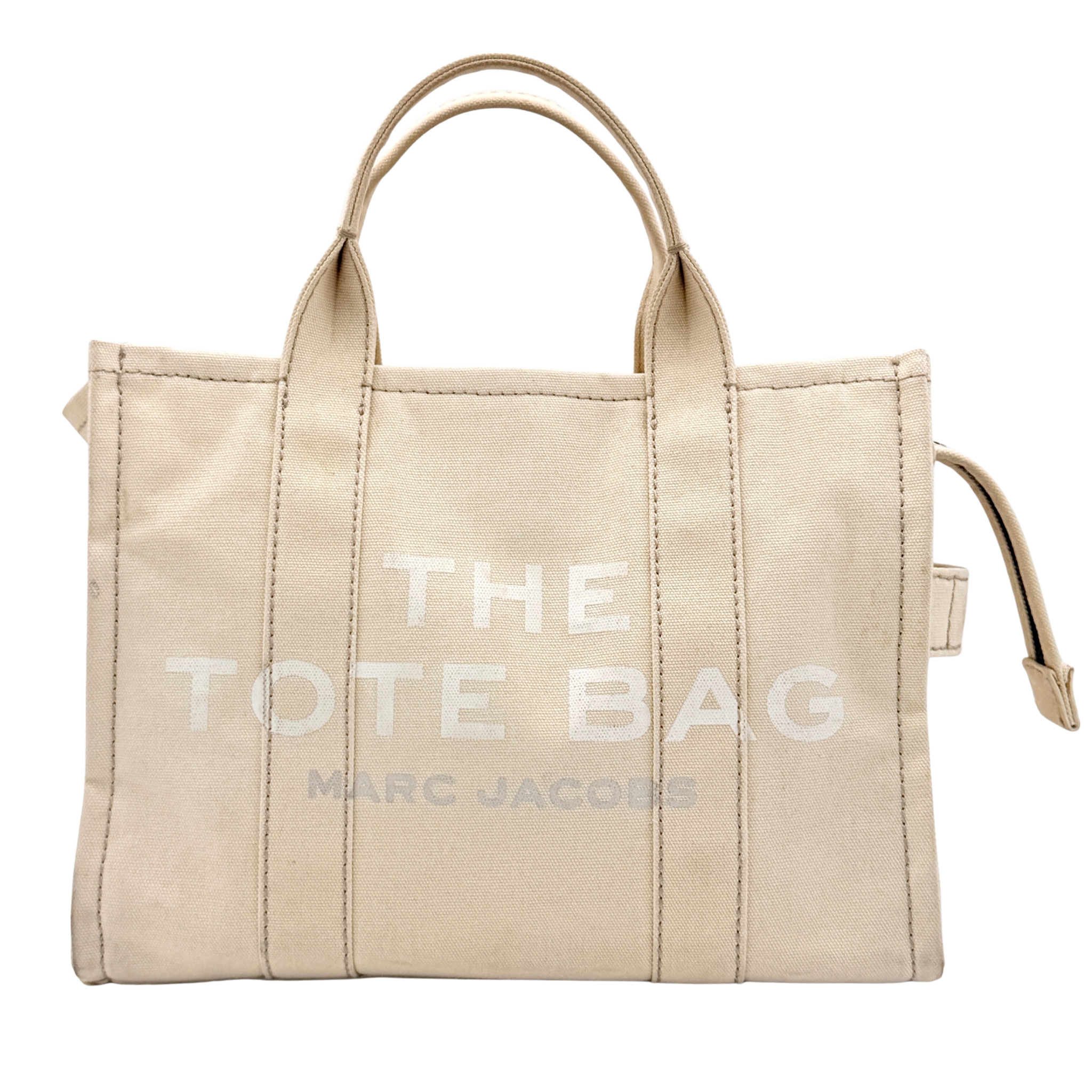 Marc Jacobs The Canvas Tote Bag in beige canvas with bold text, featuring top handles and zip closure.