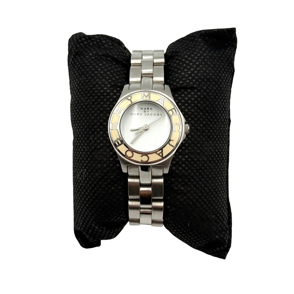 Marc Jacobs Blade MBM3049 watch in stainless steel with a cream bezel, shown on a black cushion.